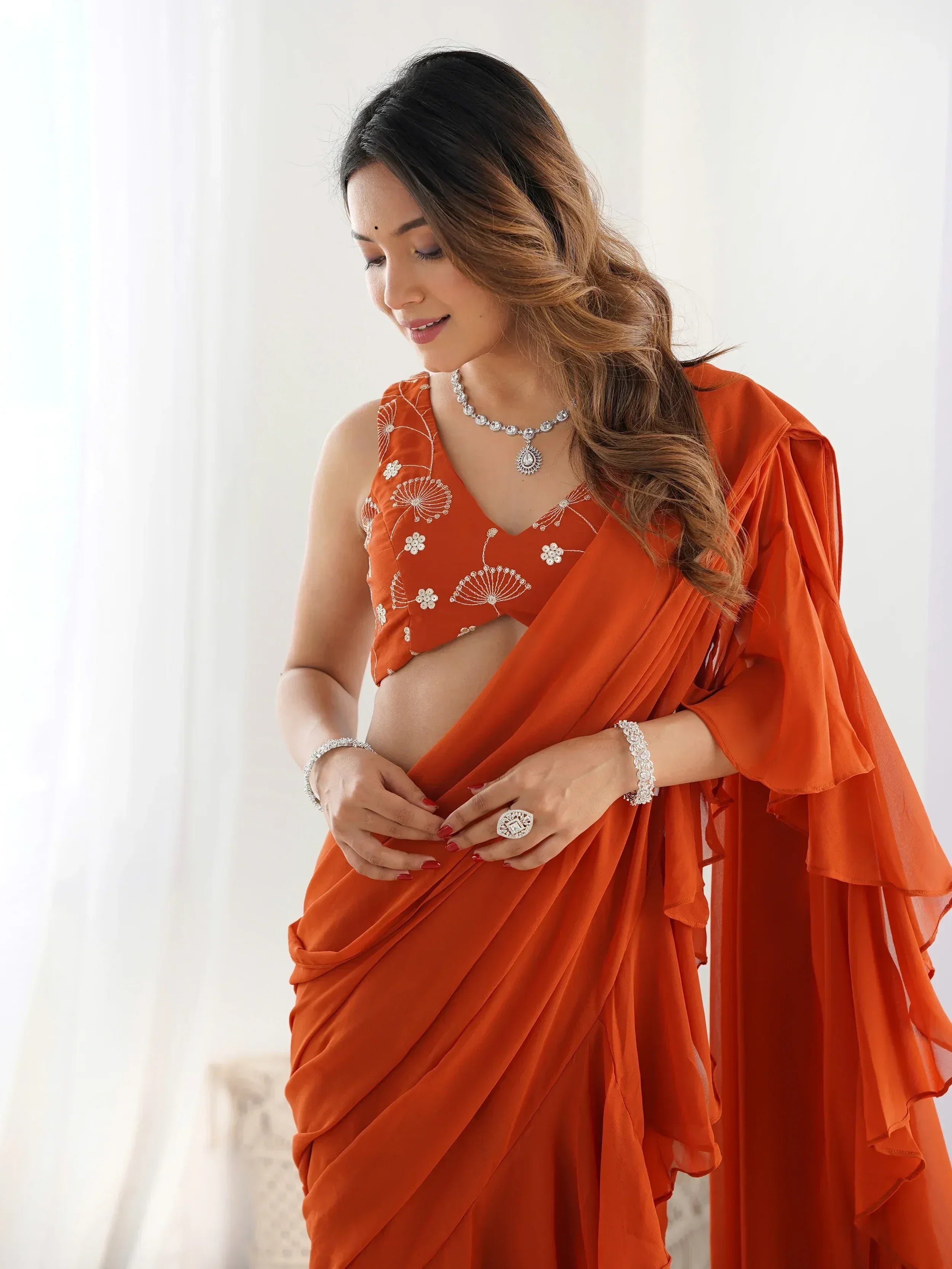 Orange embroidered saree with floral blouse, perfect for Indian ethnic wear occasions