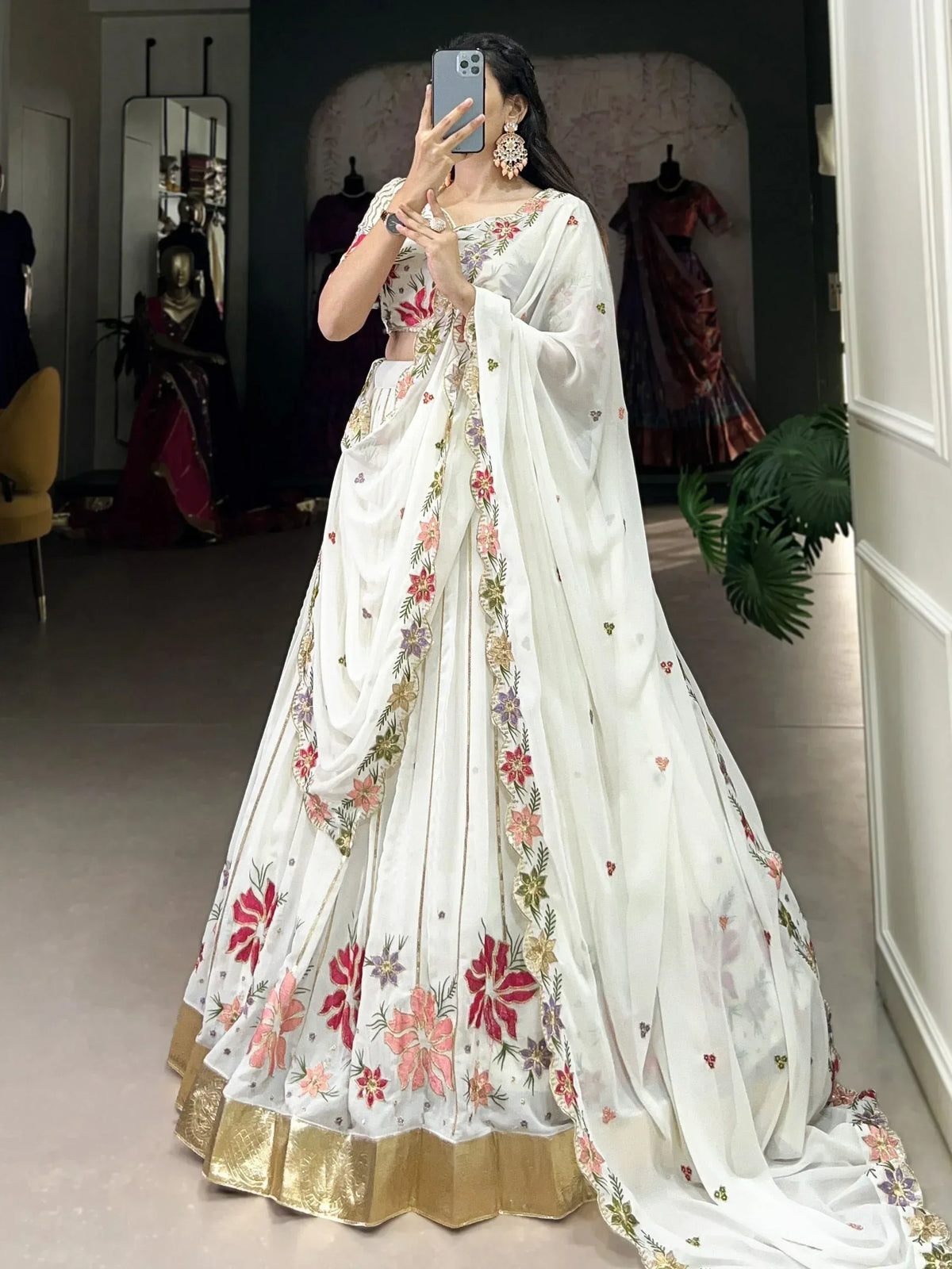 White floral embroidered lehenga choli with gold border, perfect for Indian ethnic wear occasions