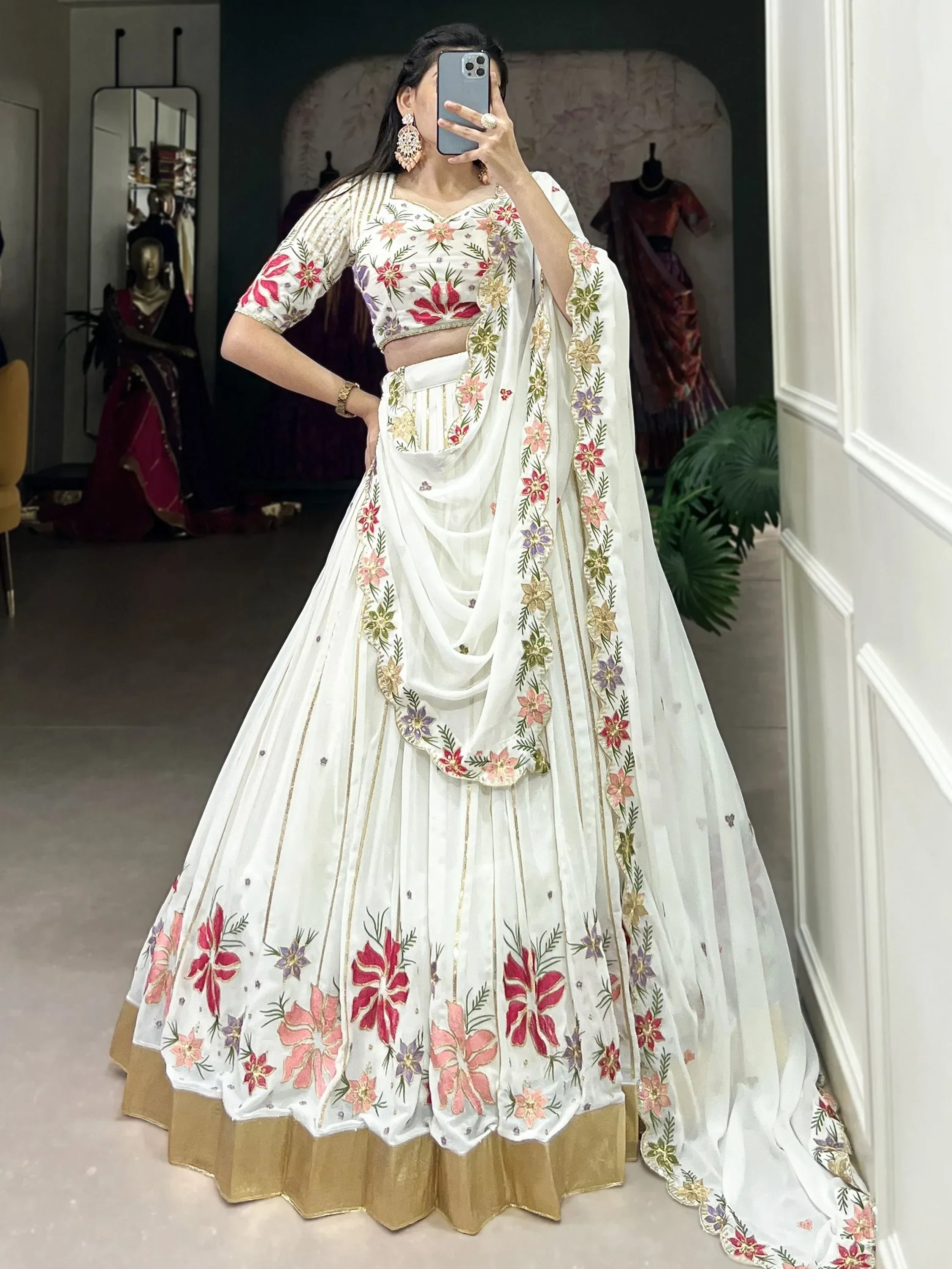 White floral embroidered lehenga choli with gold border, perfect for Indian ethnic wear occasions