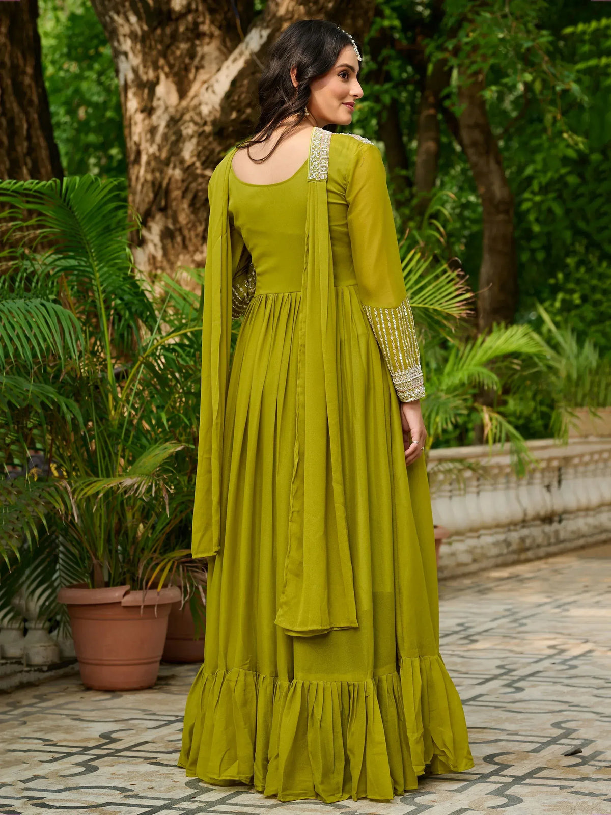 Olive green ethnic anarkali gown with embroidered sleeves and ruffled hem, perfect for Indian occasions