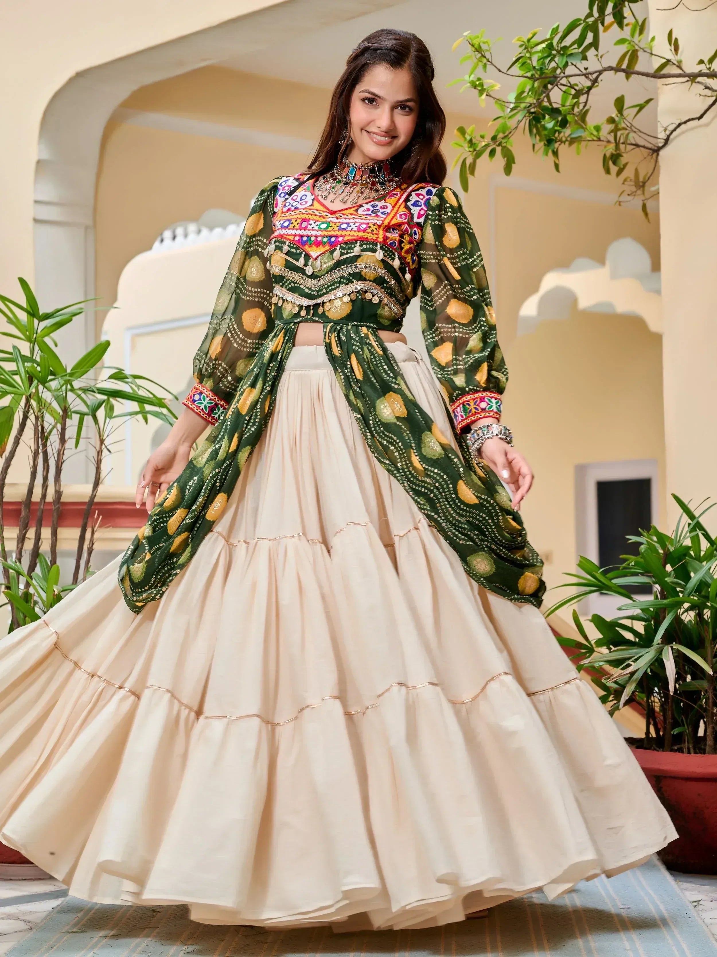 Woman in vibrant green embroidered crop top with cream tiered skirt, Indian ethnic wear
