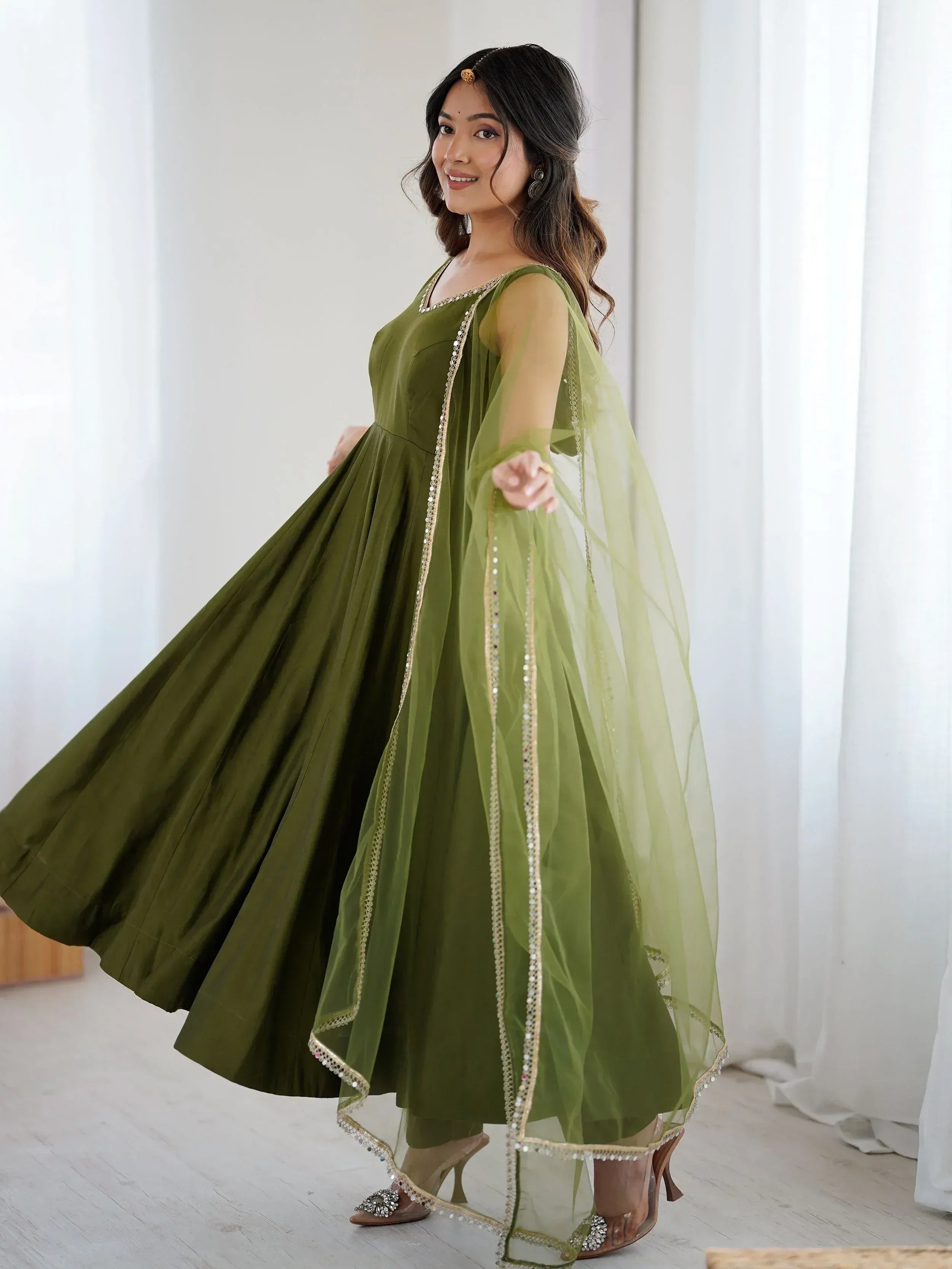 Olive green ethnic gown with sheer dupatta and gold embellishments for women