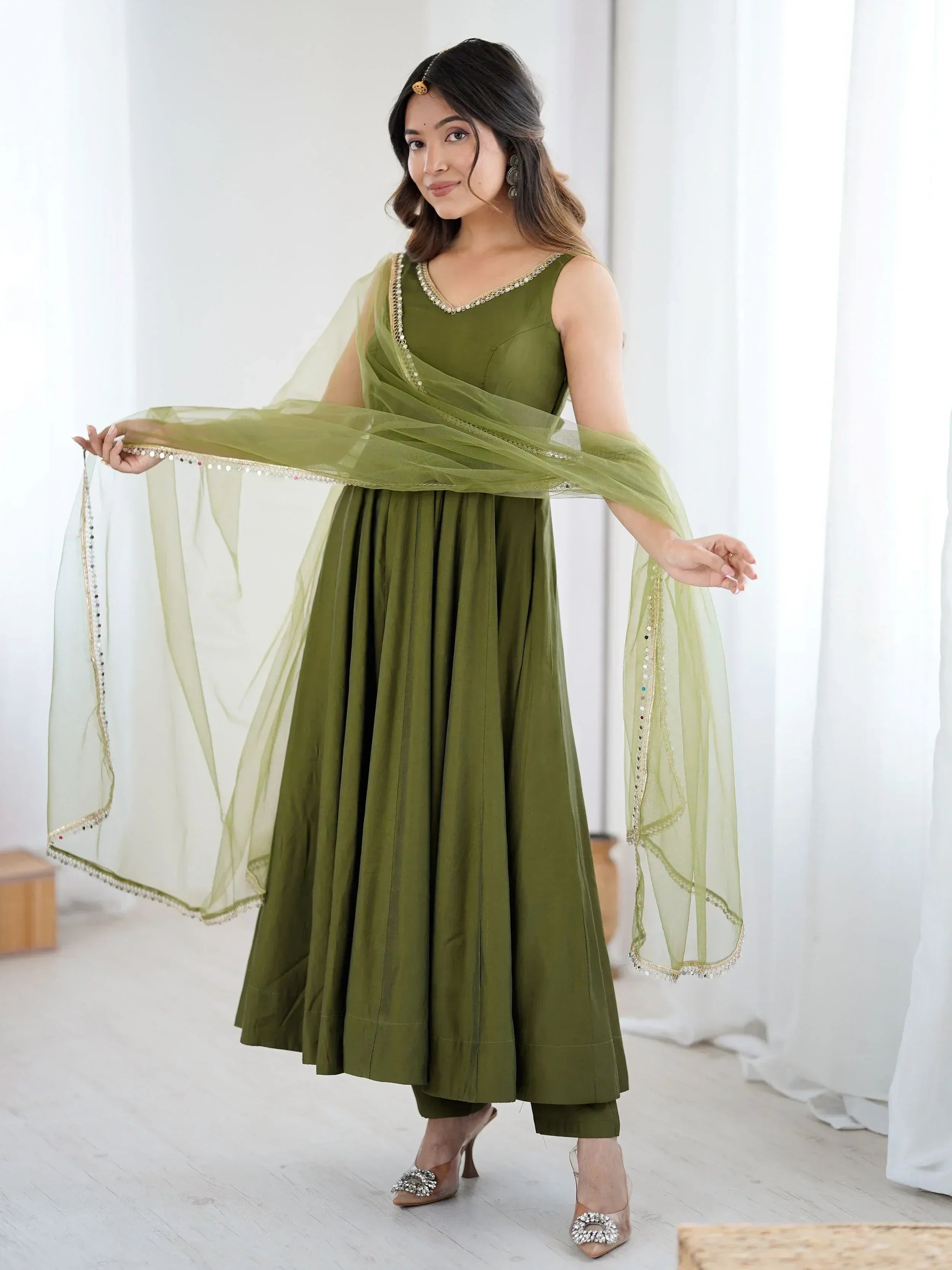 Olive green ethnic anarkali suit with sheer dupatta, perfect for Indian occasions and parties.