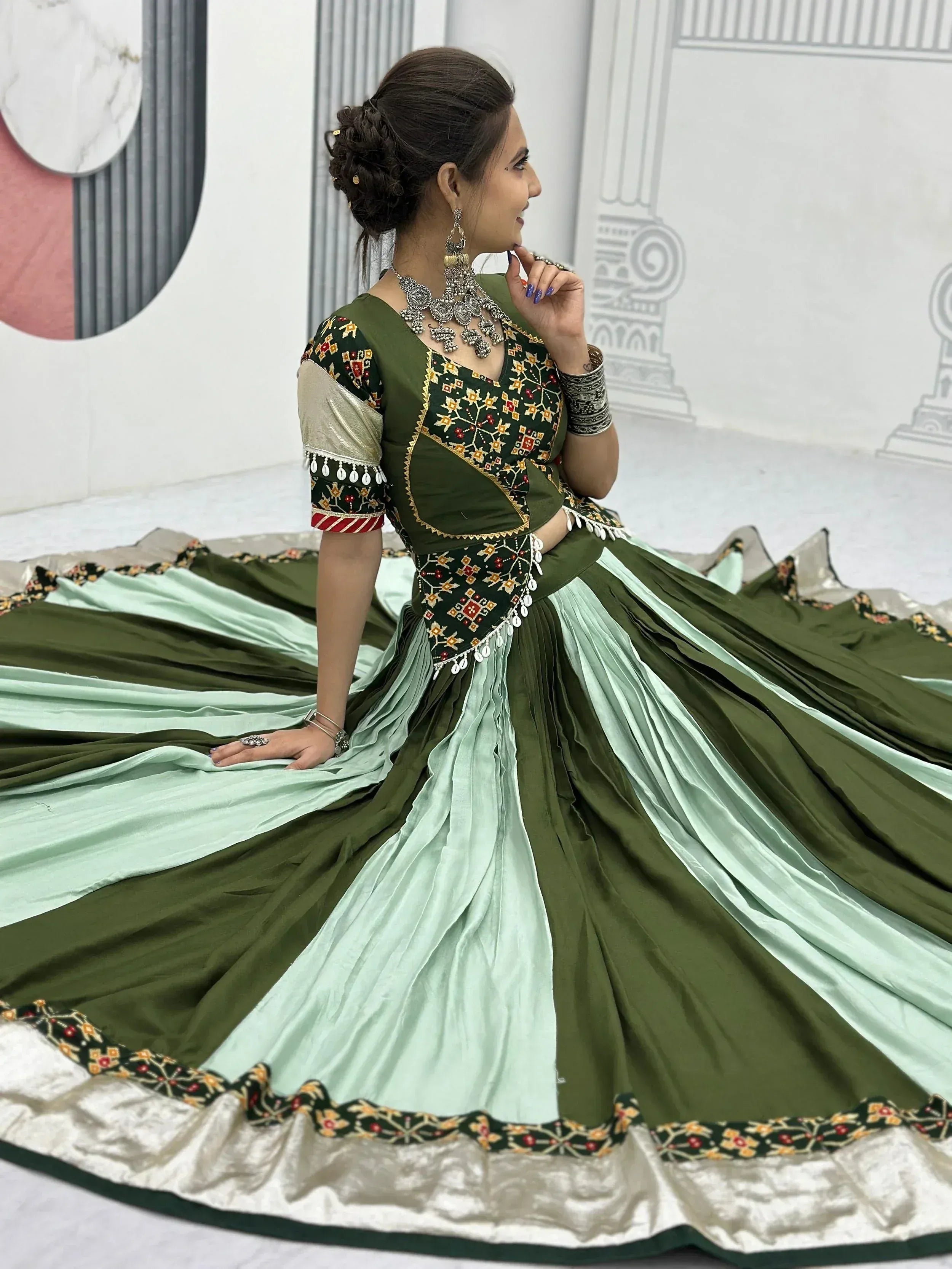 Olive green embroidered lehenga choli with mint pleated skirt, perfect for Indian ethnic wear events.