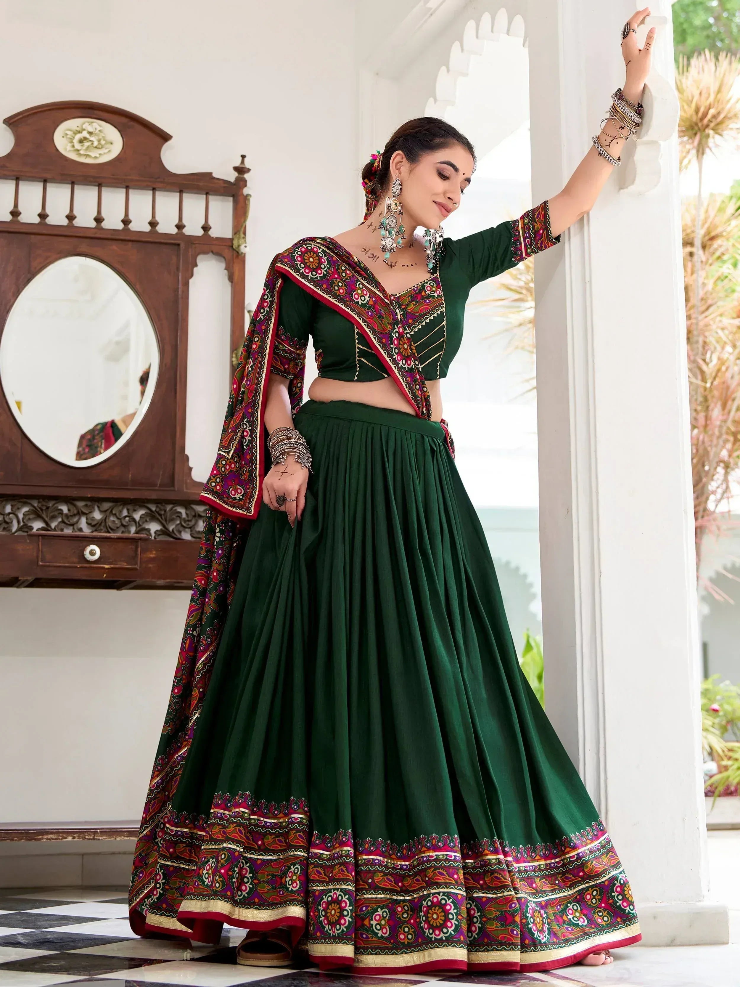 Emerald green embroidered lehenga choli with colorful floral border, perfect for Indian ethnic wear occasions.