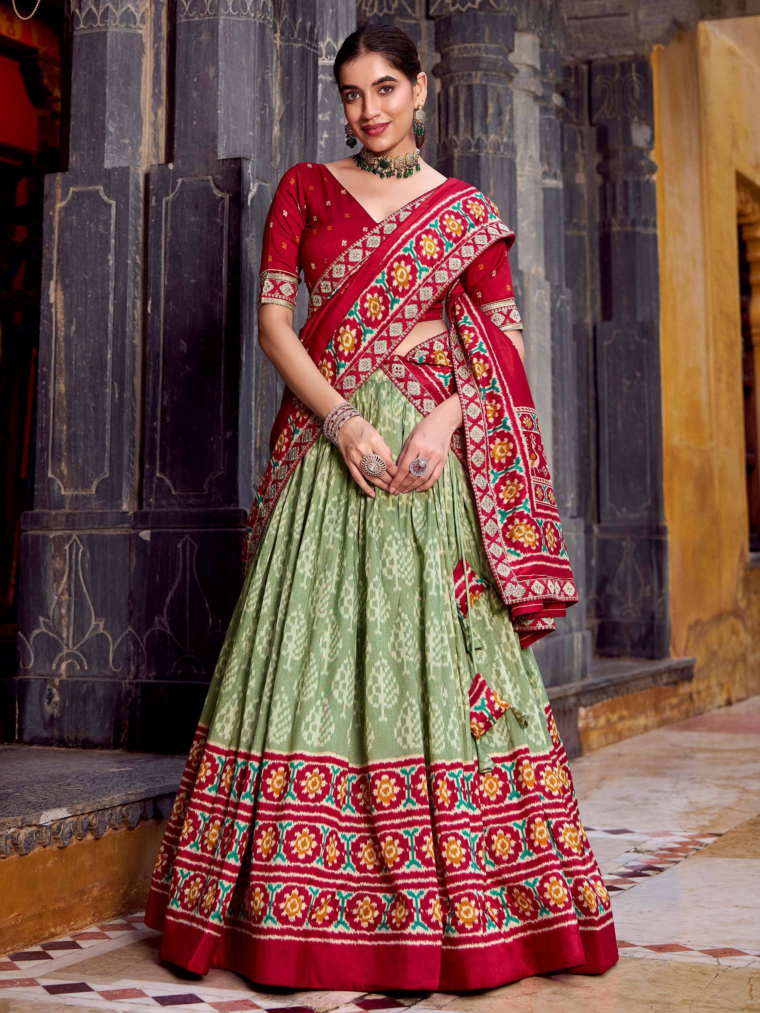 Red and green printed lehenga choli with ethnic motifs, perfect for Indian weddings and festivals