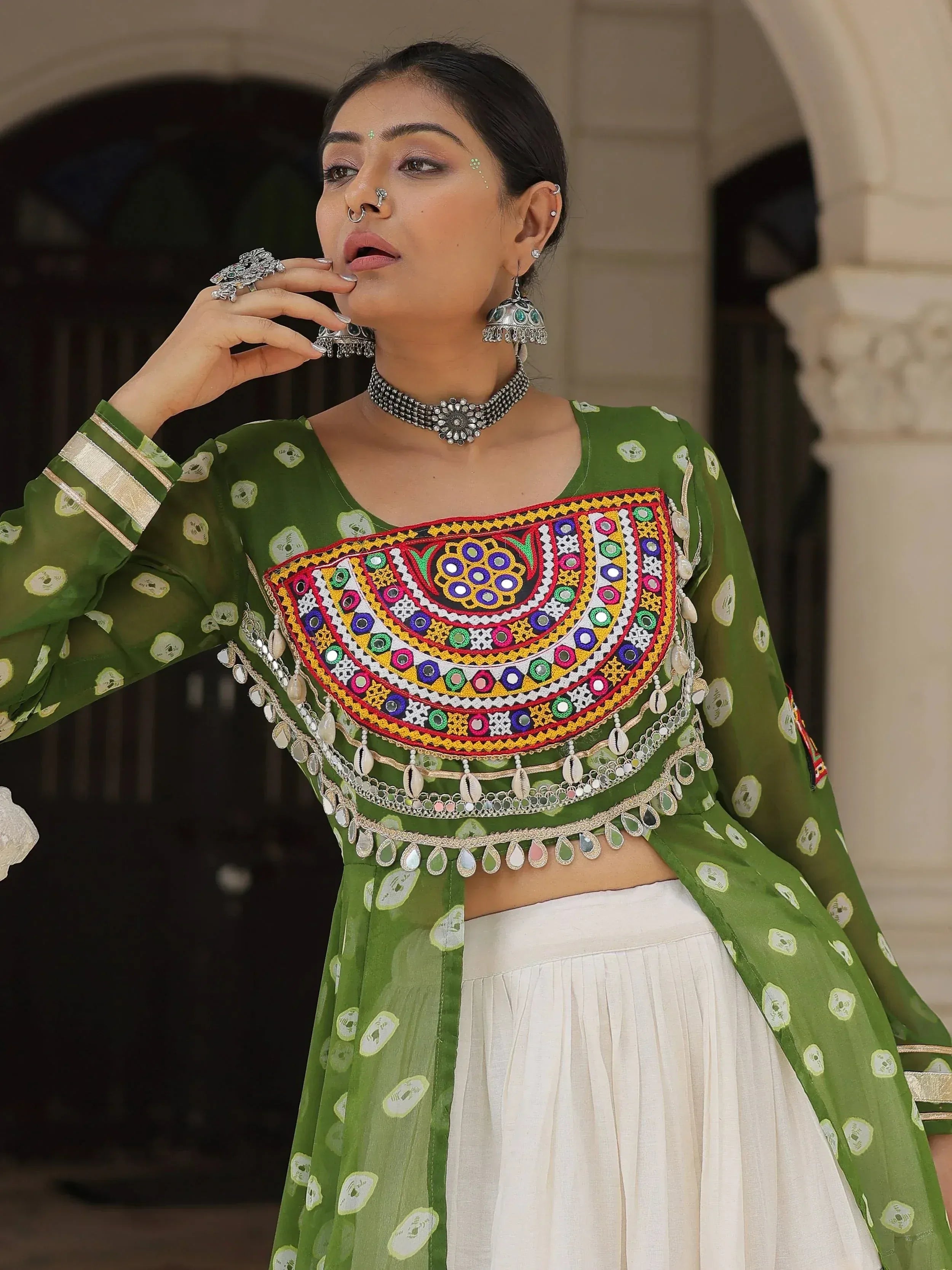 Green embroidered ethnic top with mirror work and white skirt, traditional Indian wear