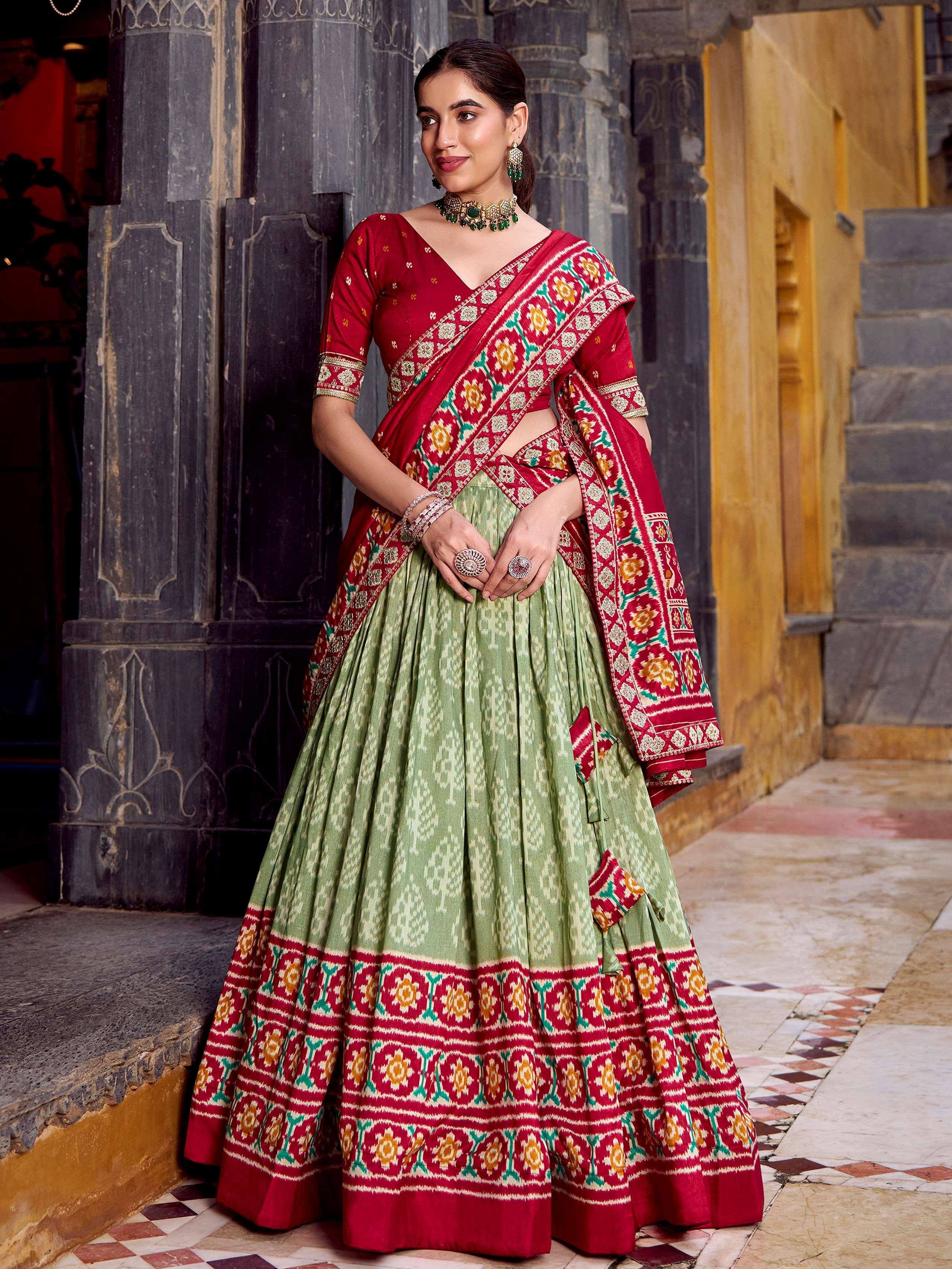 Red and green printed lehenga choli with ethnic embroidery, perfect for Indian weddings and festive occasions