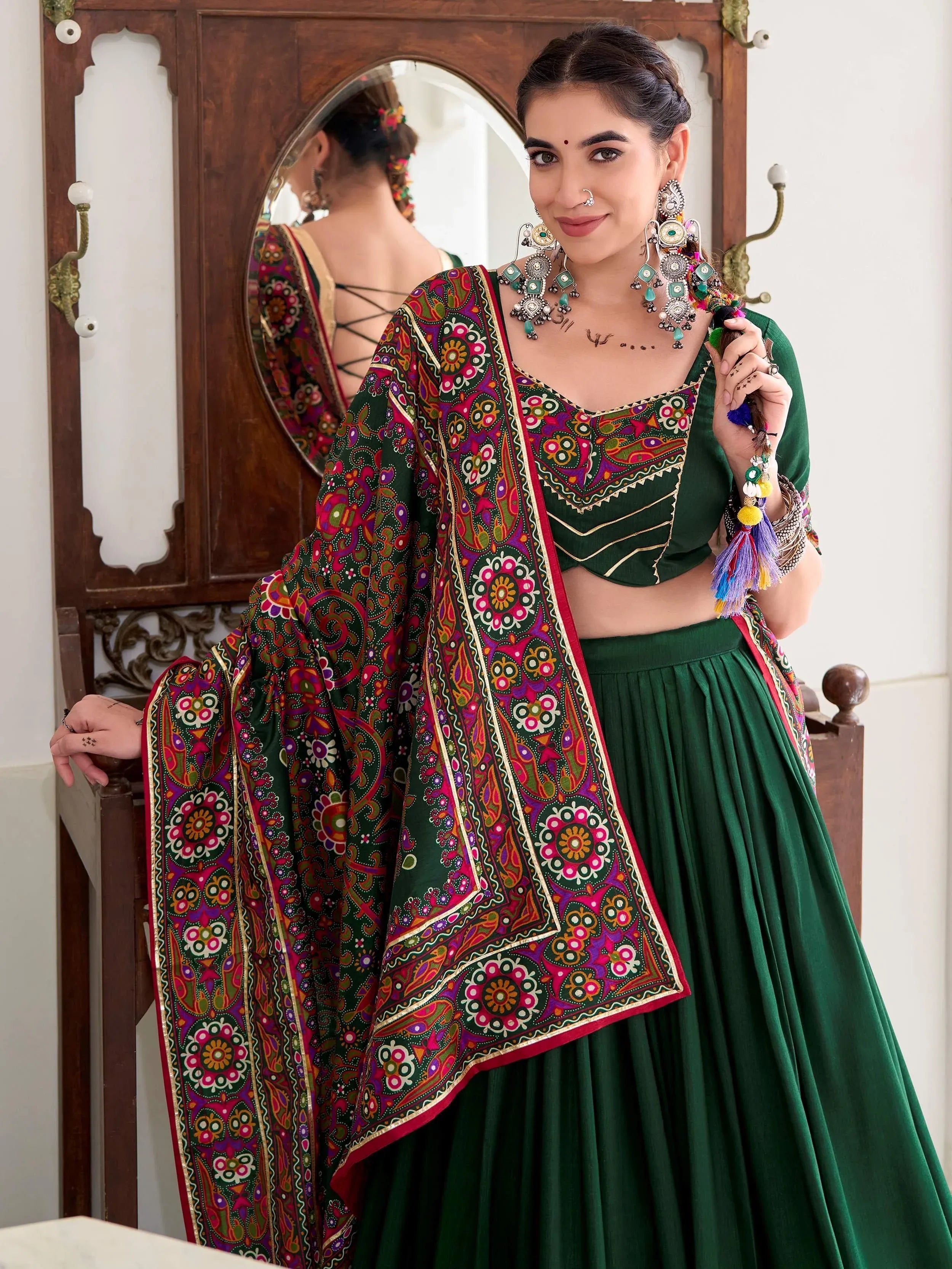 Green embroidered lehenga choli with colorful dupatta, traditional Indian ethnic wear
