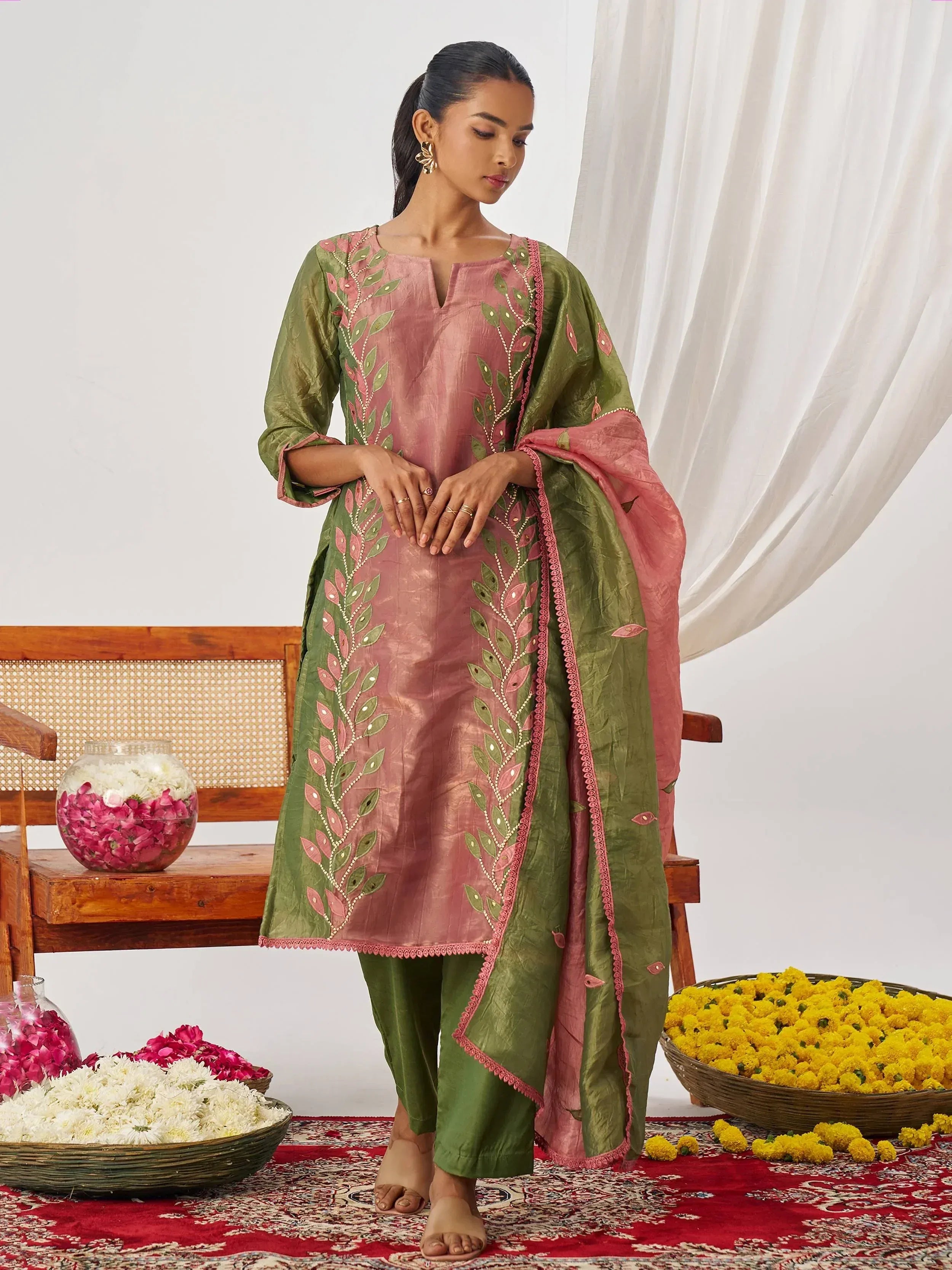 Pink and green embroidered salwar kameez with floral motifs, perfect for ethnic occasions