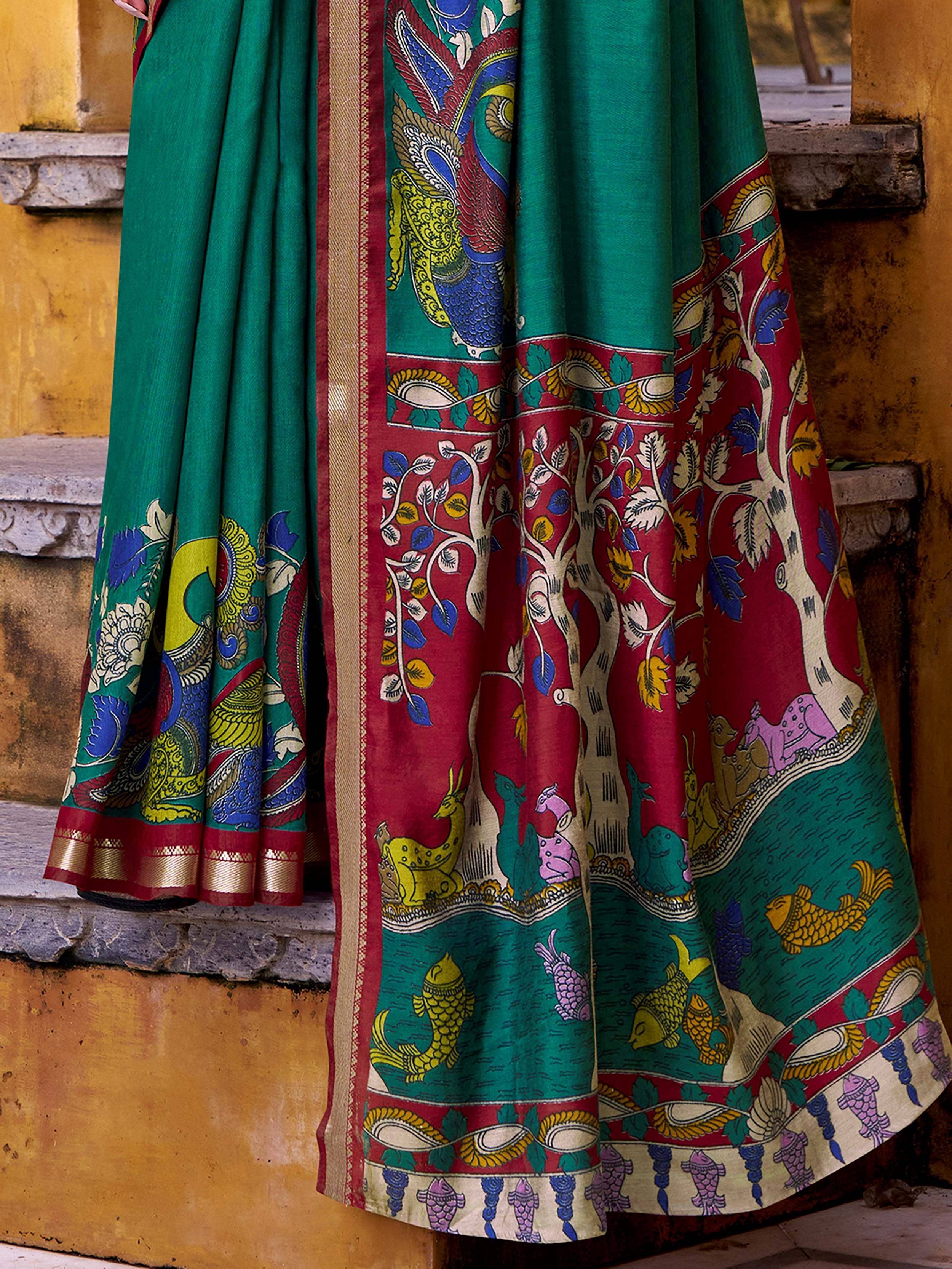 Green and red Indian saree with peacock, tree, and fish motifs, traditional ethnic wear