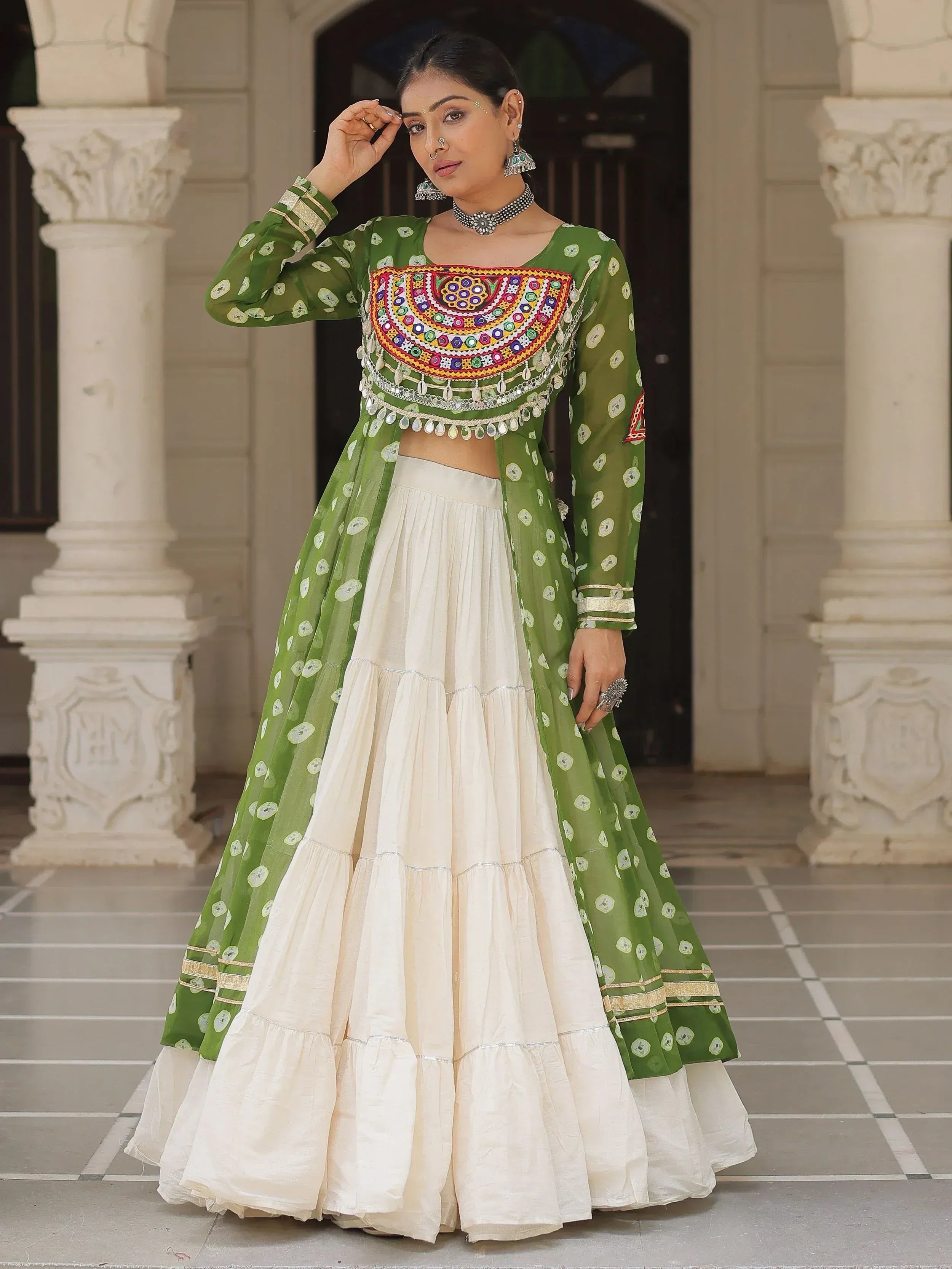 Green and cream Indian ethnic lehenga choli with mirror work and polka dots, perfect for festive occasions.