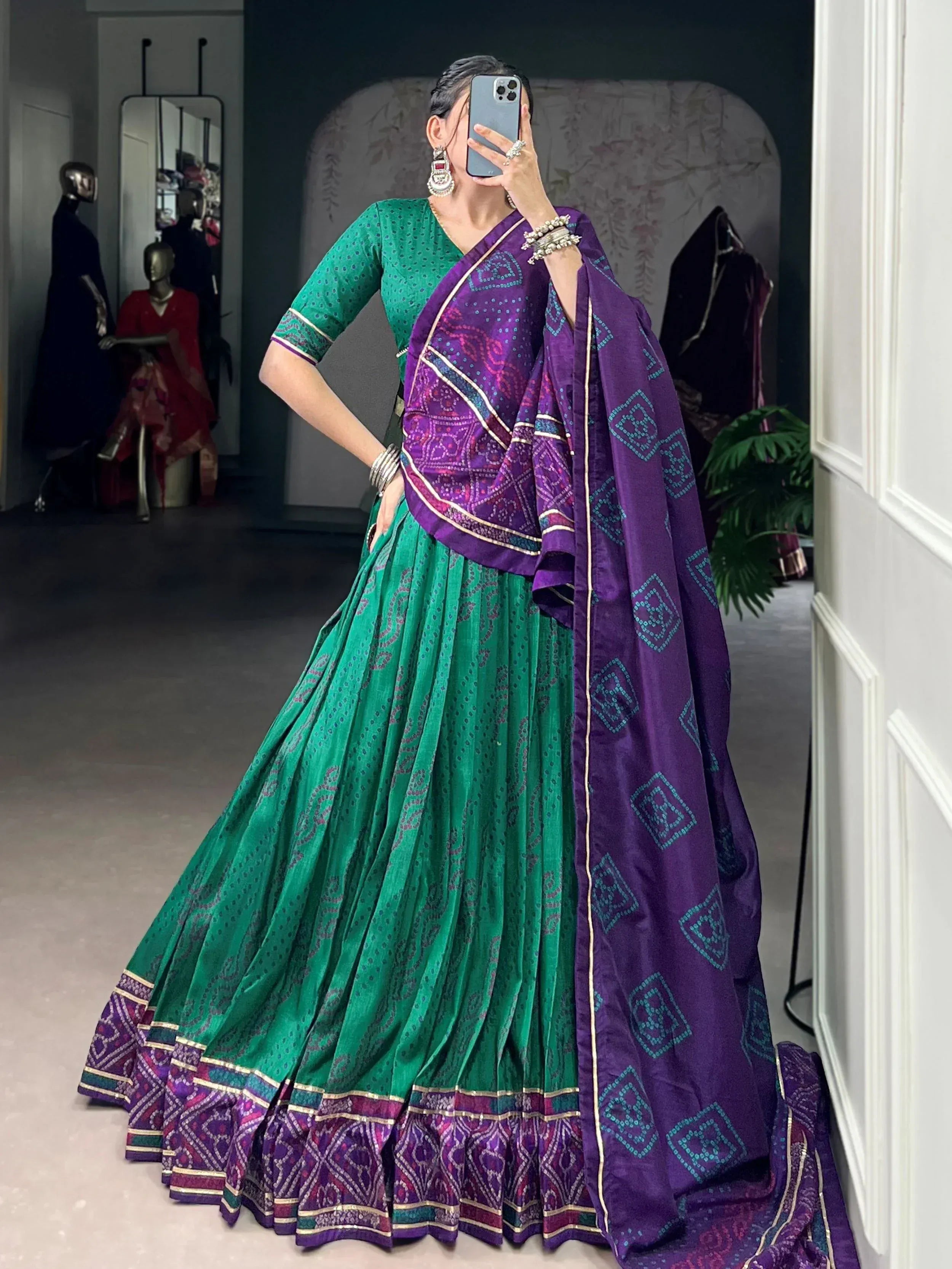 Green and purple printed lehenga choli with ethnic embroidery, perfect for Indian festive occasions.