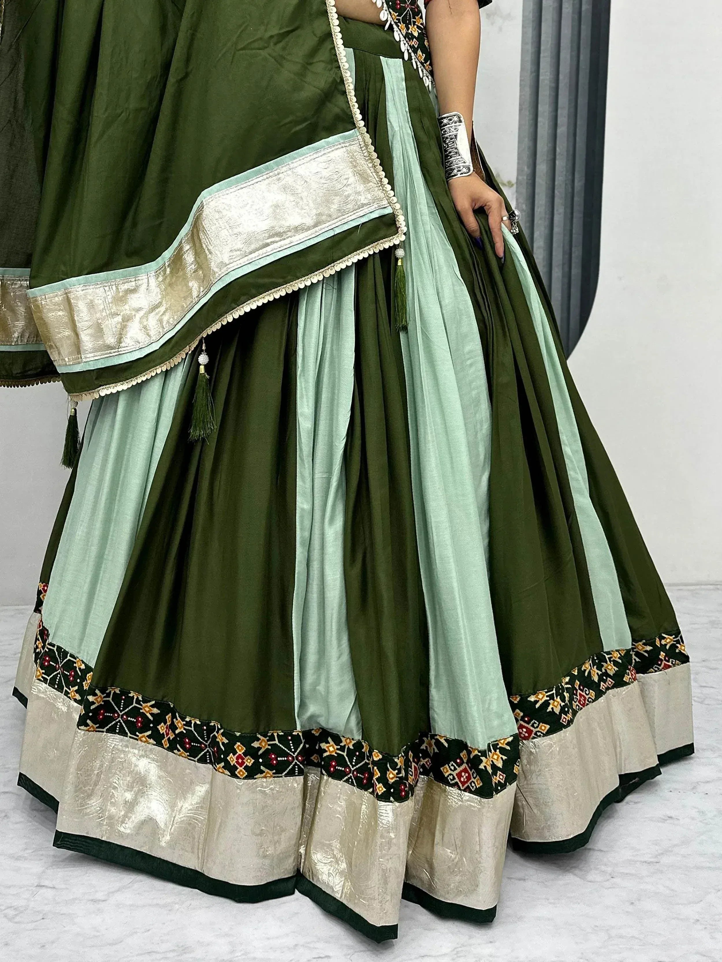 Olive green and mint lehenga choli with embroidered border and gold trim, Indian ethnic wear