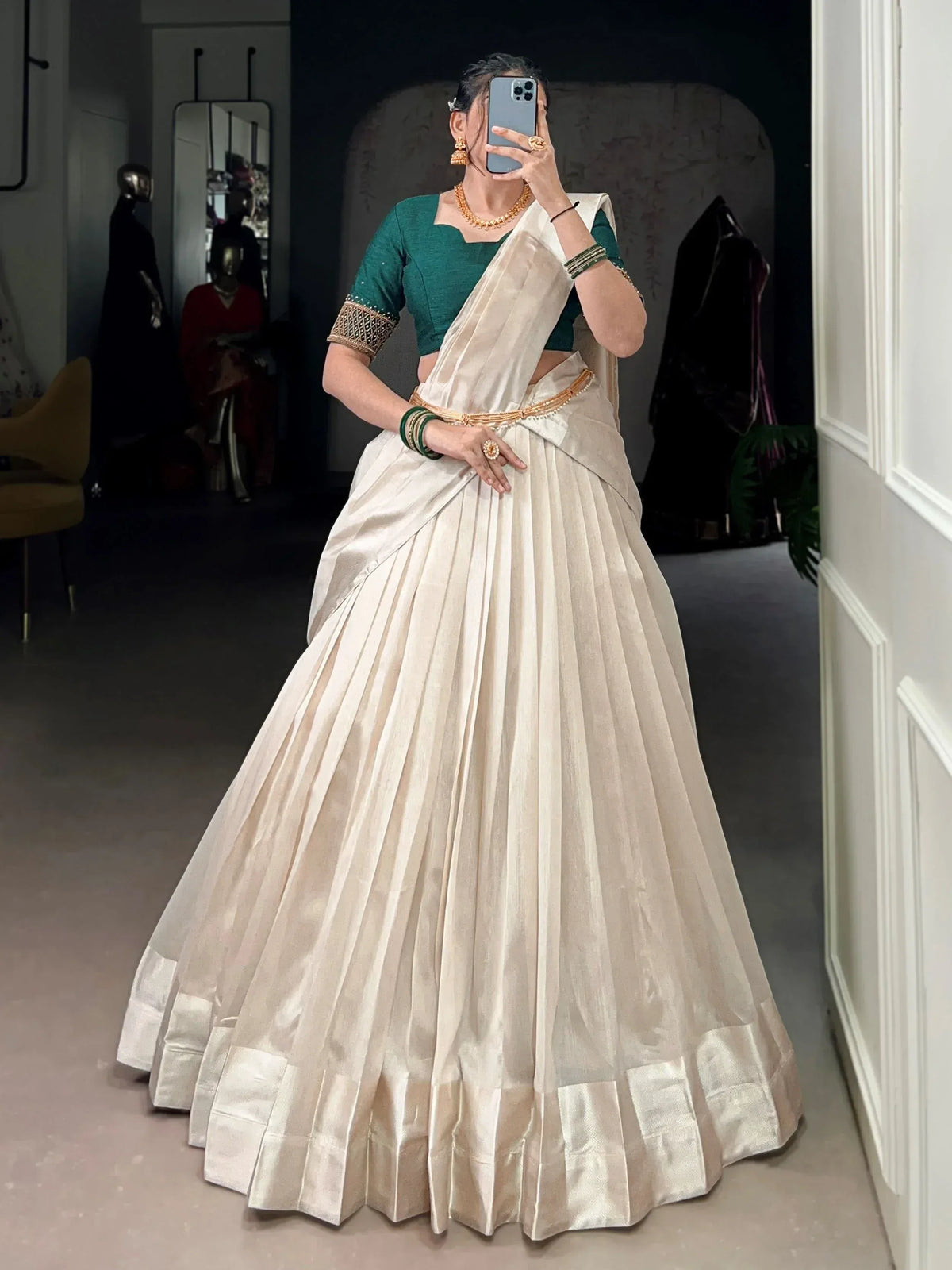 Elegant ivory pleated saree with green blouse, perfect for Indian ethnic wear occasions