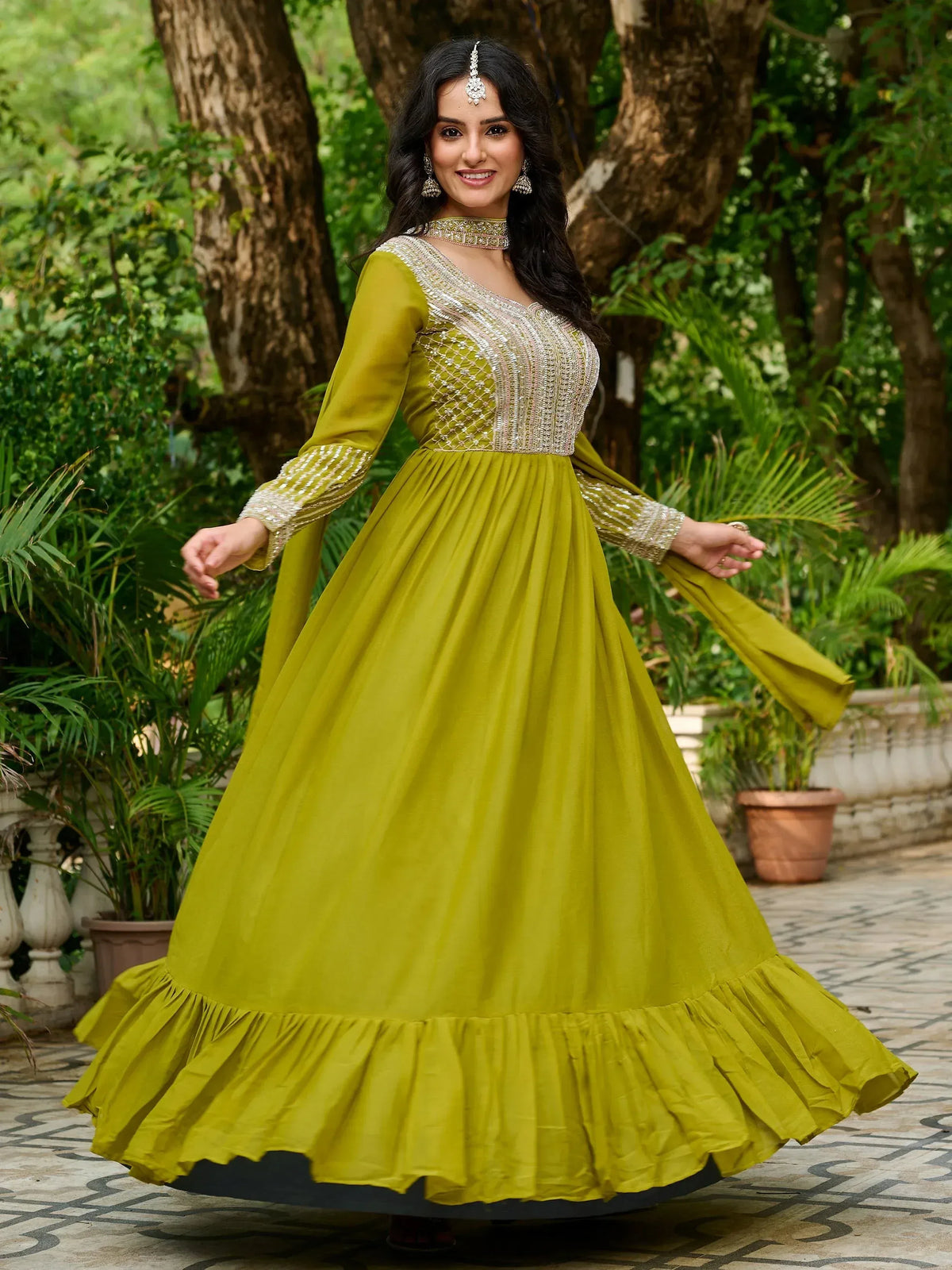 Olive green ethnic gown with silver embroidery, perfect for Indian occasions and festive wear.