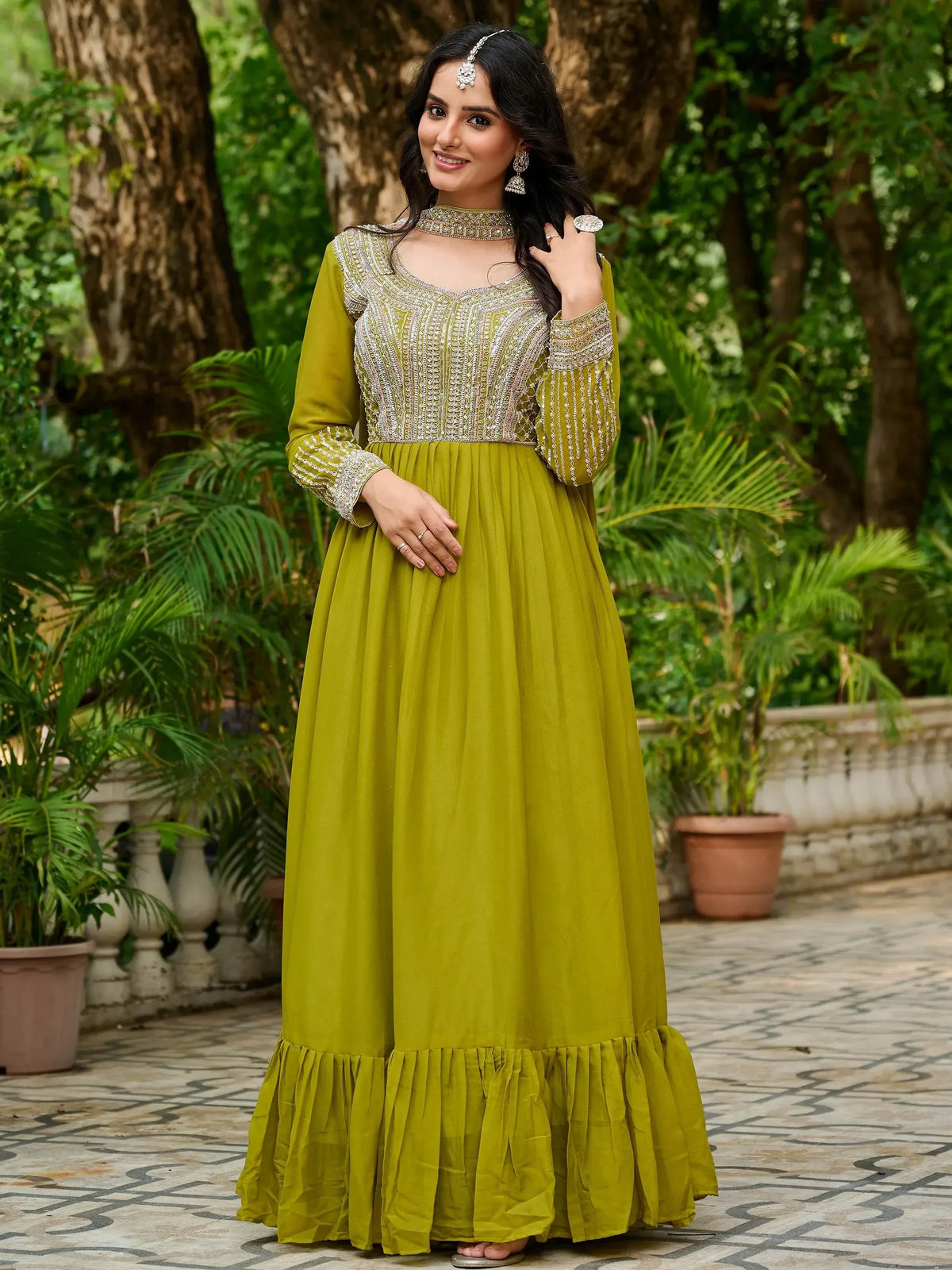 Olive green embroidered ethnic gown with ruffled hem, perfect for Indian occasions and festive wear.