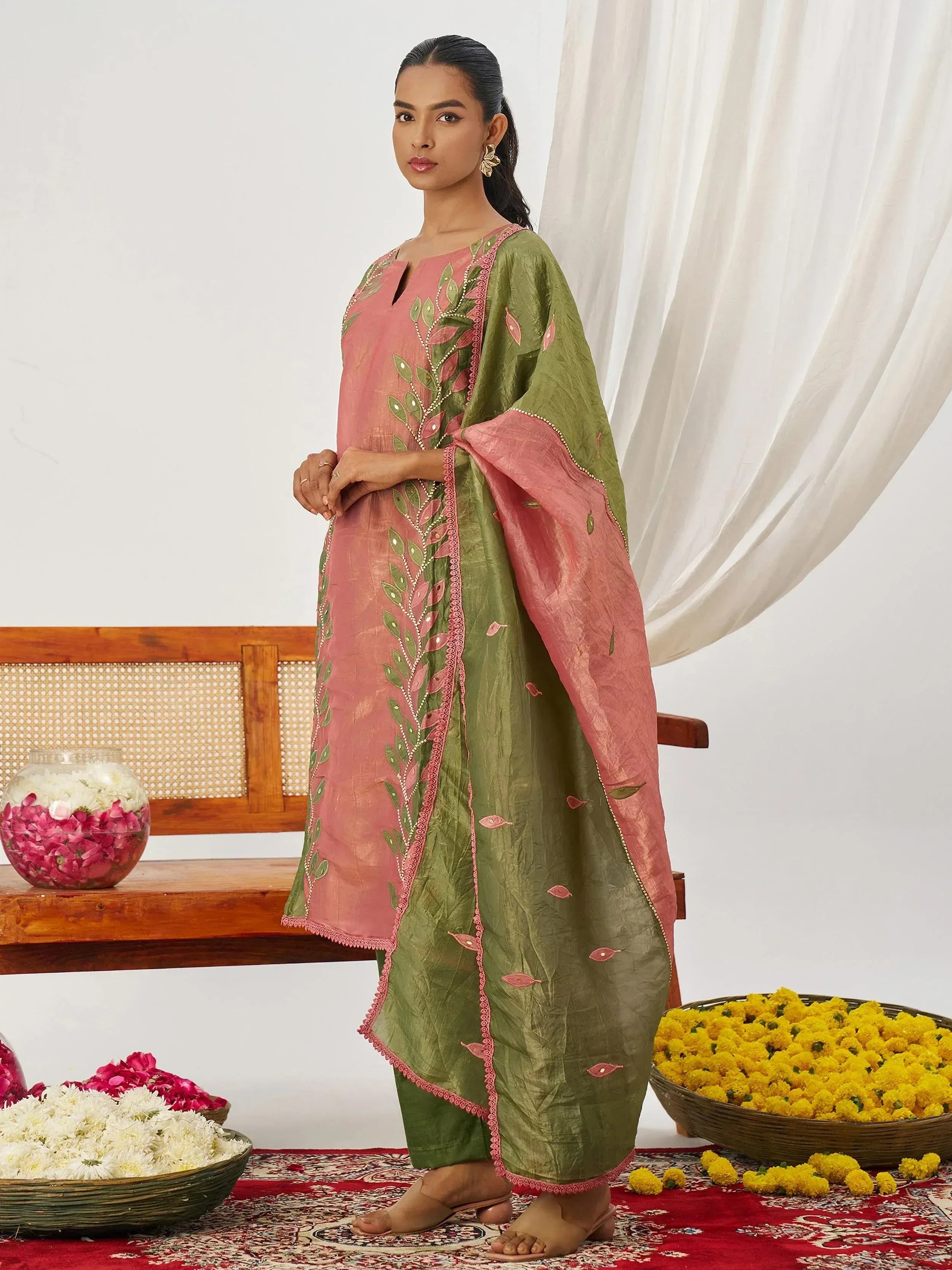Pink and olive green embroidered salwar kameez with floral motifs, perfect for ethnic occasions
