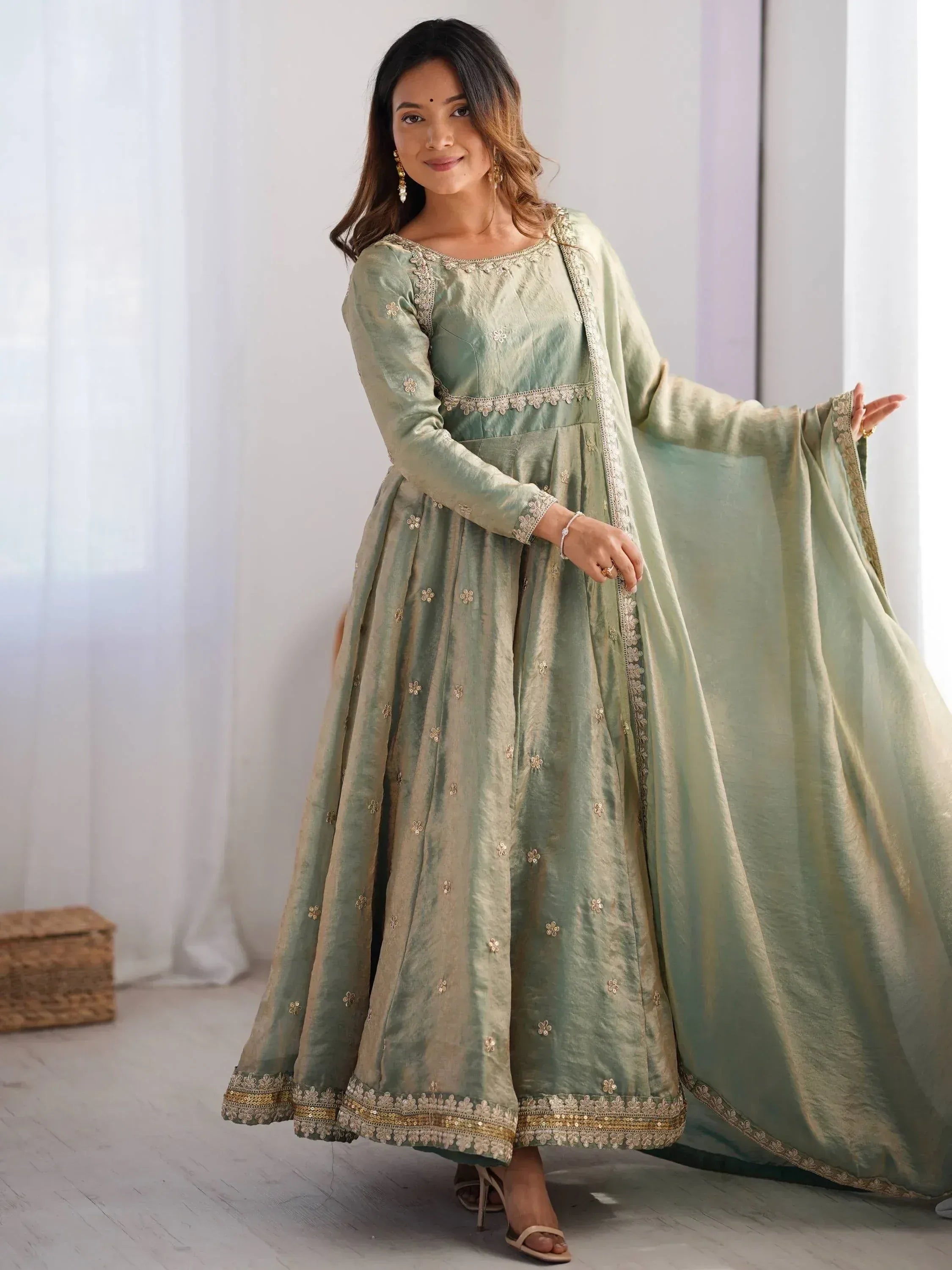 Woman in mint green embroidered ethnic gown with dupatta, Indian festive wear