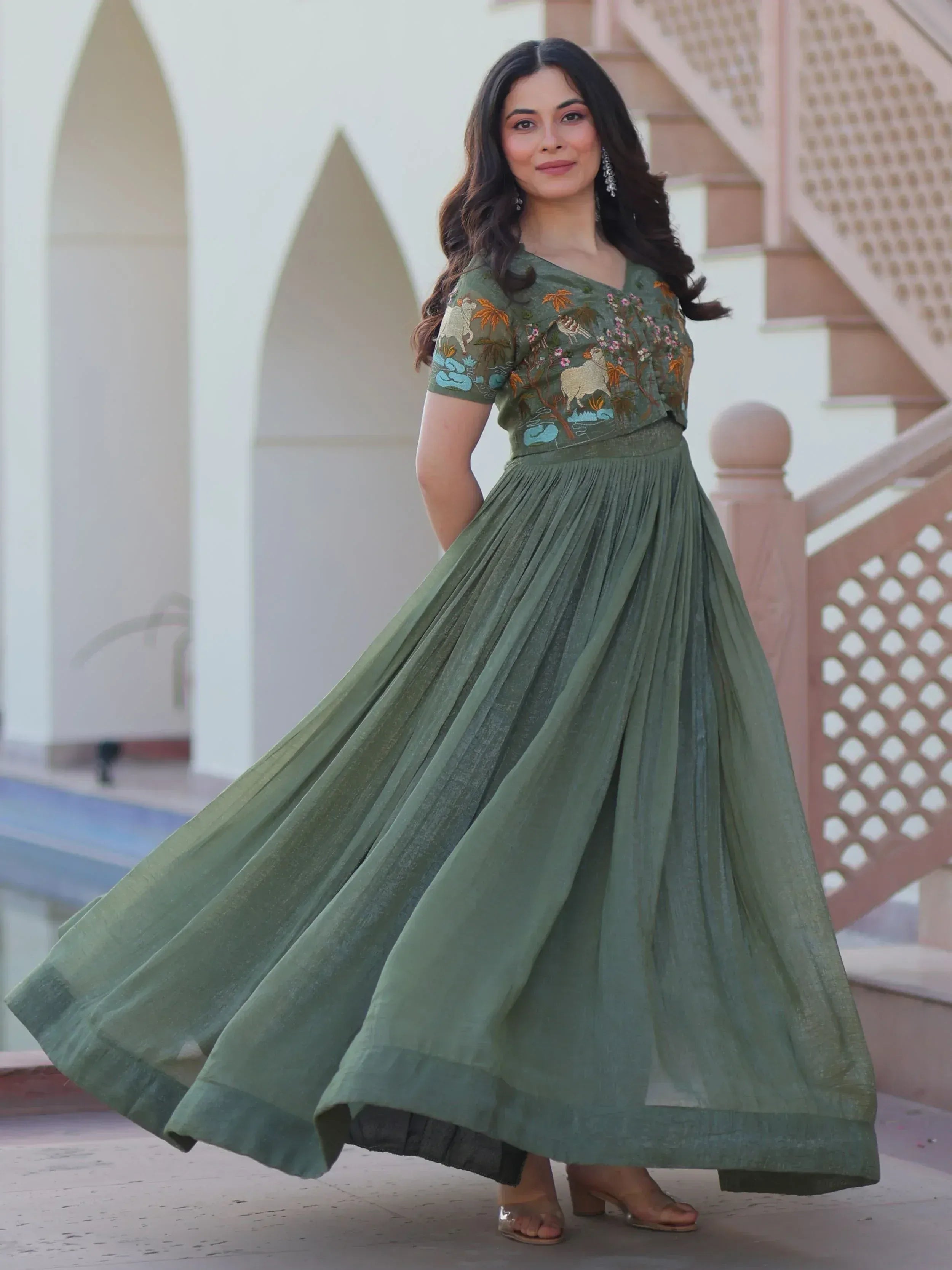 Olive green embroidered ethnic gown with pleated skirt, perfect for Indian occasions and festive wear.