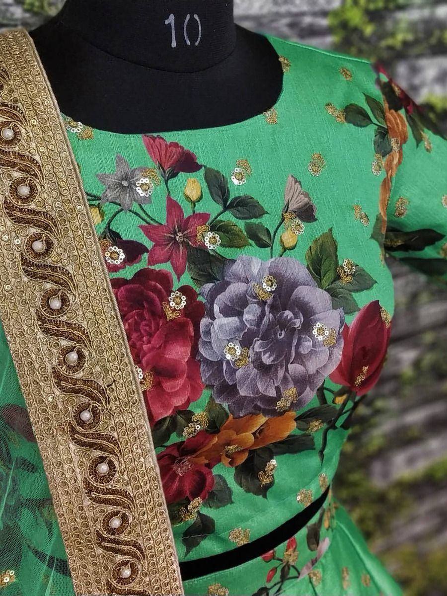 Green floral print ethnic gown with gold embroidery and pearl detailing, perfect for Indian occasions