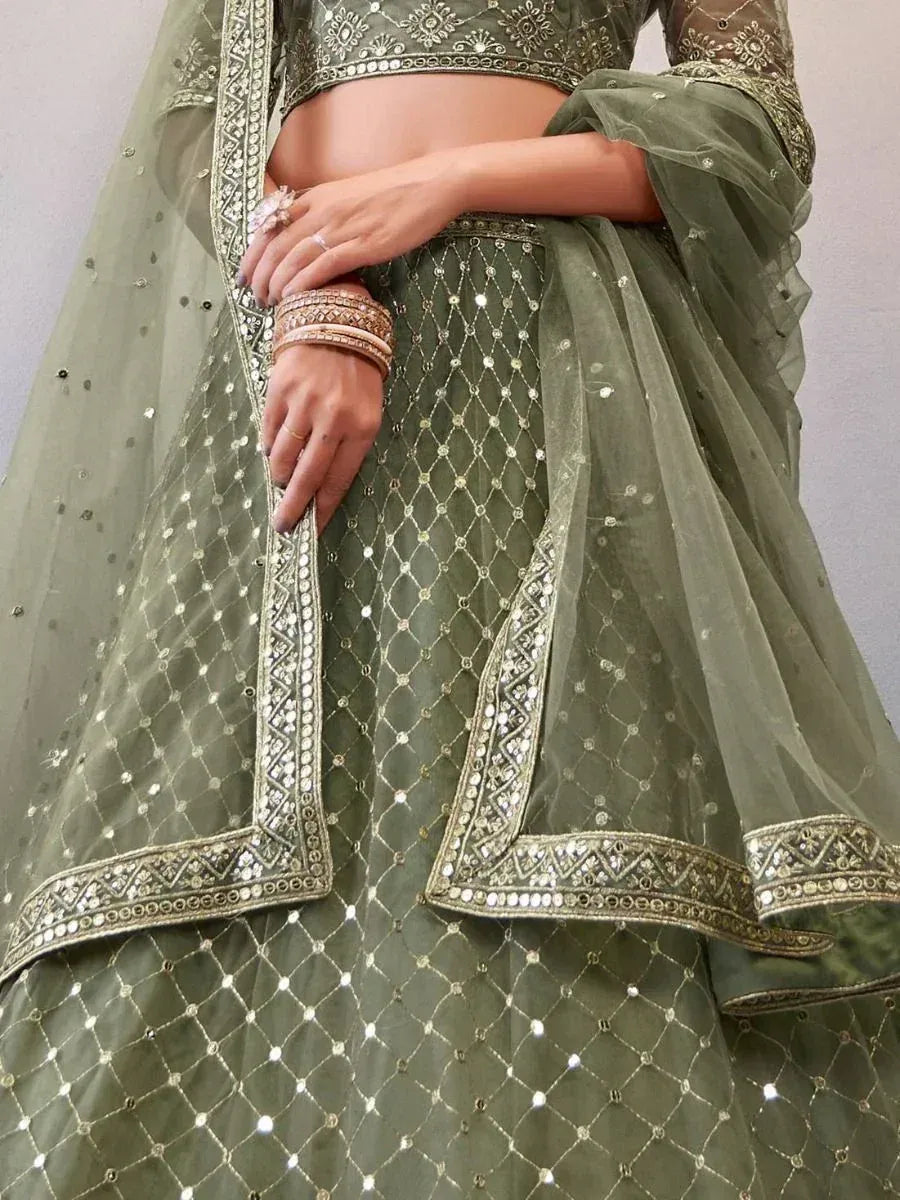Olive green designer lehenga choli with intricate mirror work and gold embroidery, perfect for Indian ethnic wear.