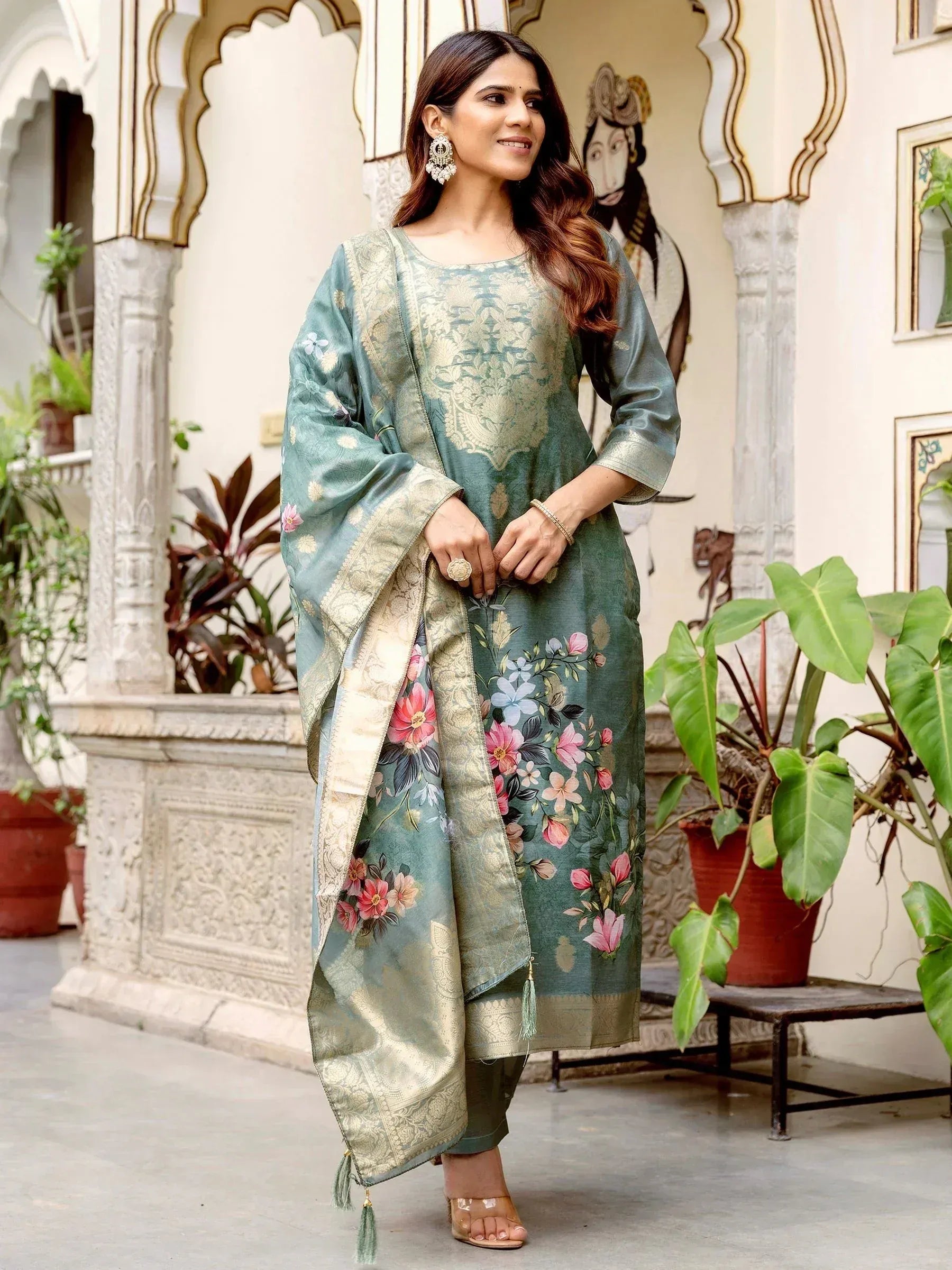 Woman in teal floral printed ethnic kurta with gold embroidery and matching dupatta, traditional Indian wear