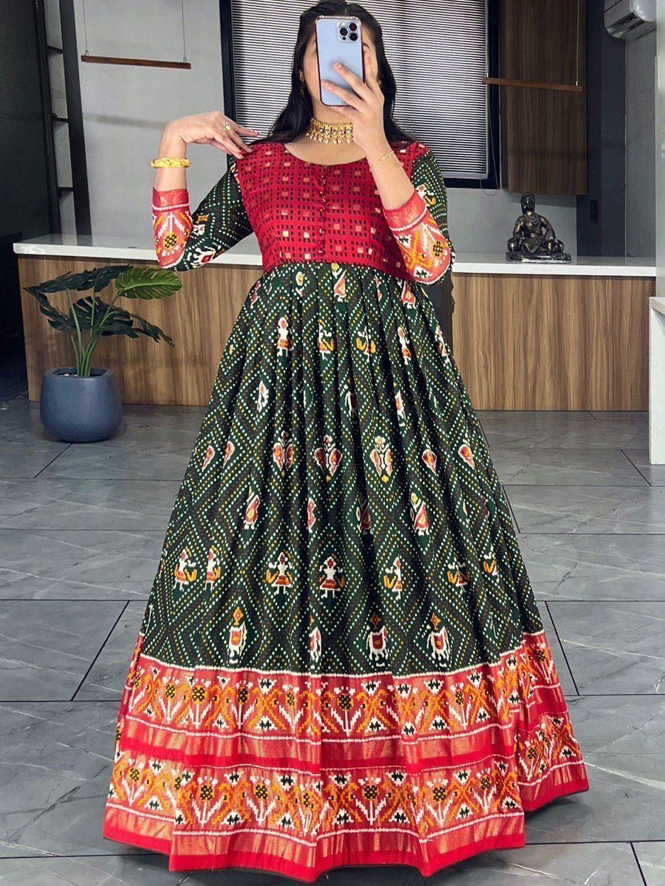 Woman in green and red traditional ethnic gown with folk print and full sleeves