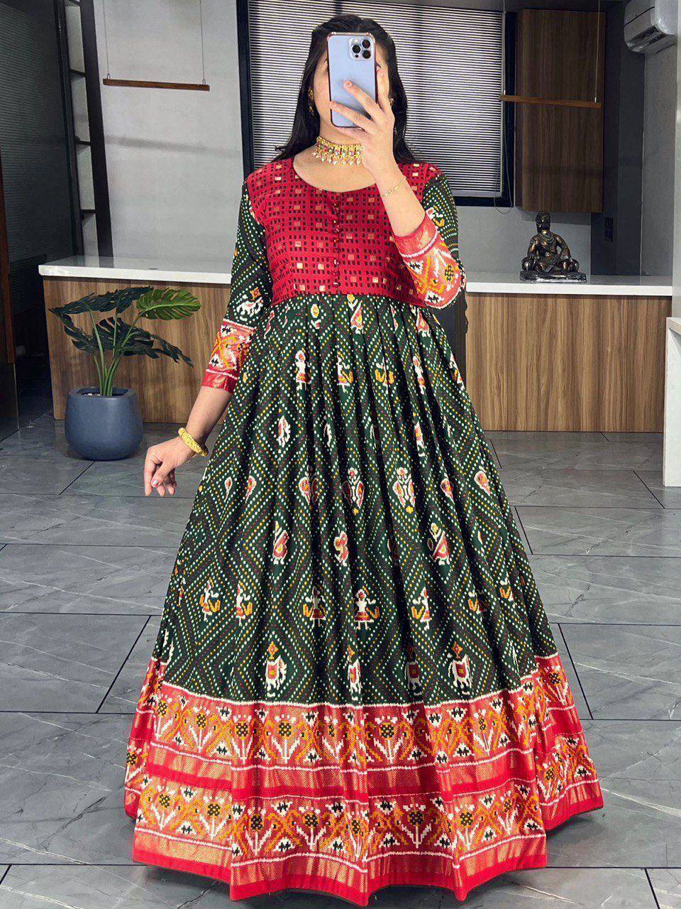Woman wearing green and red printed ethnic anarkali gown with embroidery, perfect for Indian occasions