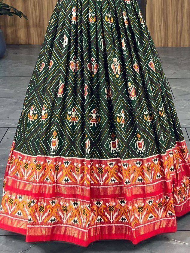 Green and red ethnic lehenga skirt with intricate folk print and border detailing