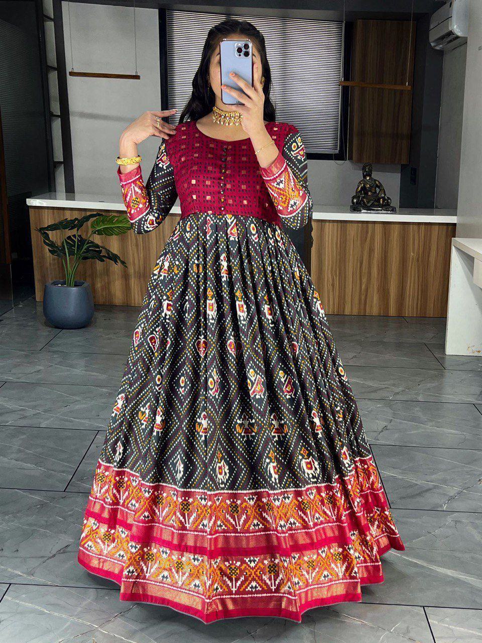 Woman wearing traditional Indian ethnic gown with geometric and floral patterns, full sleeves
