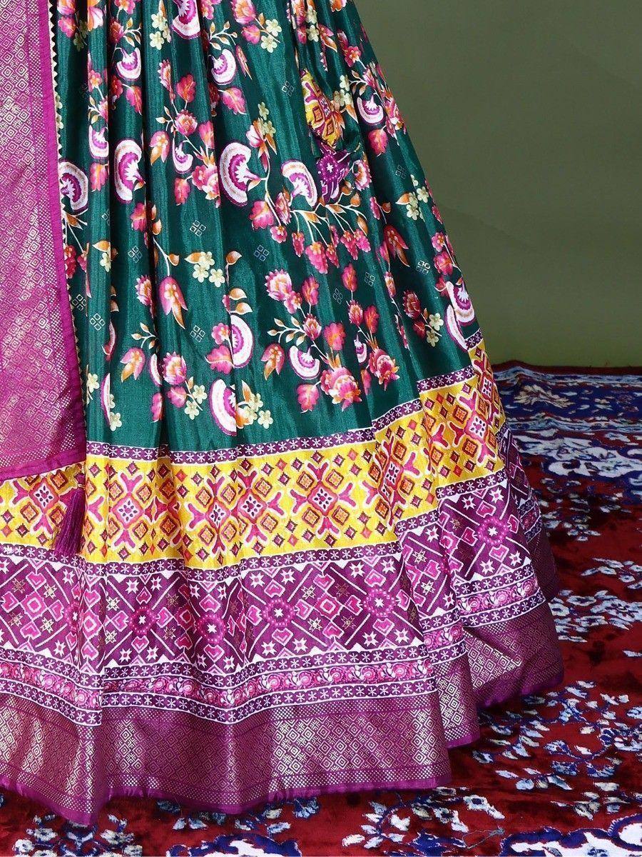 Green floral lehenga with pink and yellow border, ethnic Indian wear on patterned rug