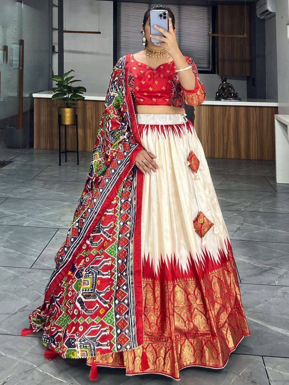 Red and cream ethnic lehenga choli with printed dupatta, perfect for Indian weddings and festive occasions.