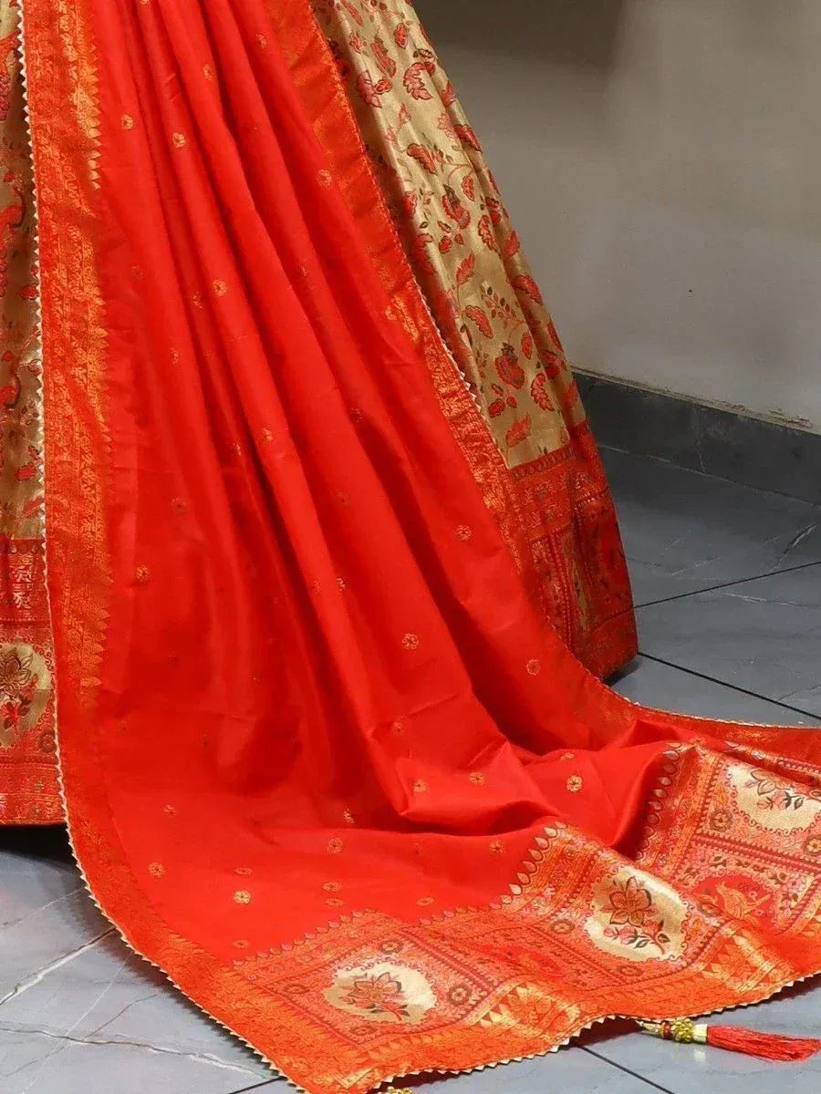 Red and gold embroidered lehenga choli with floral motifs and tassels, ideal for Indian weddings and festive occasions.