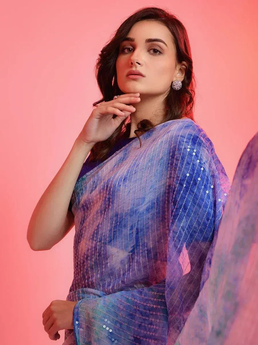 Woman in blue-purple tie-dye saree with sequins, ethnic wear for festive occasions