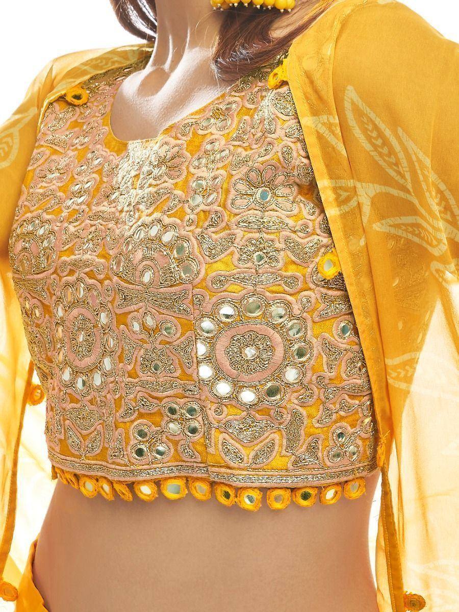 Yellow embroidered lehenga choli blouse with mirror work and floral detailing, perfect for Indian ethnic wear.