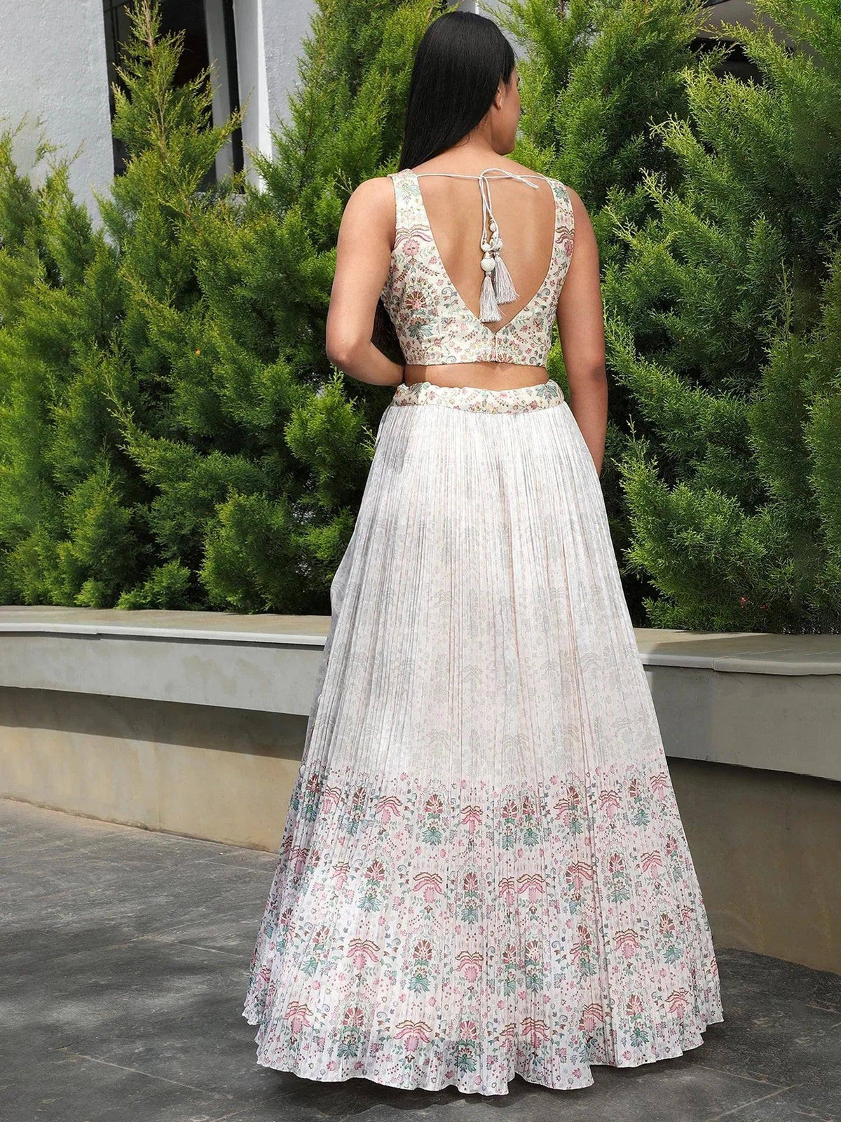 Floral print lehenga choli with back tie detail, pleated skirt, and tassel accents for Indian ethnic wear