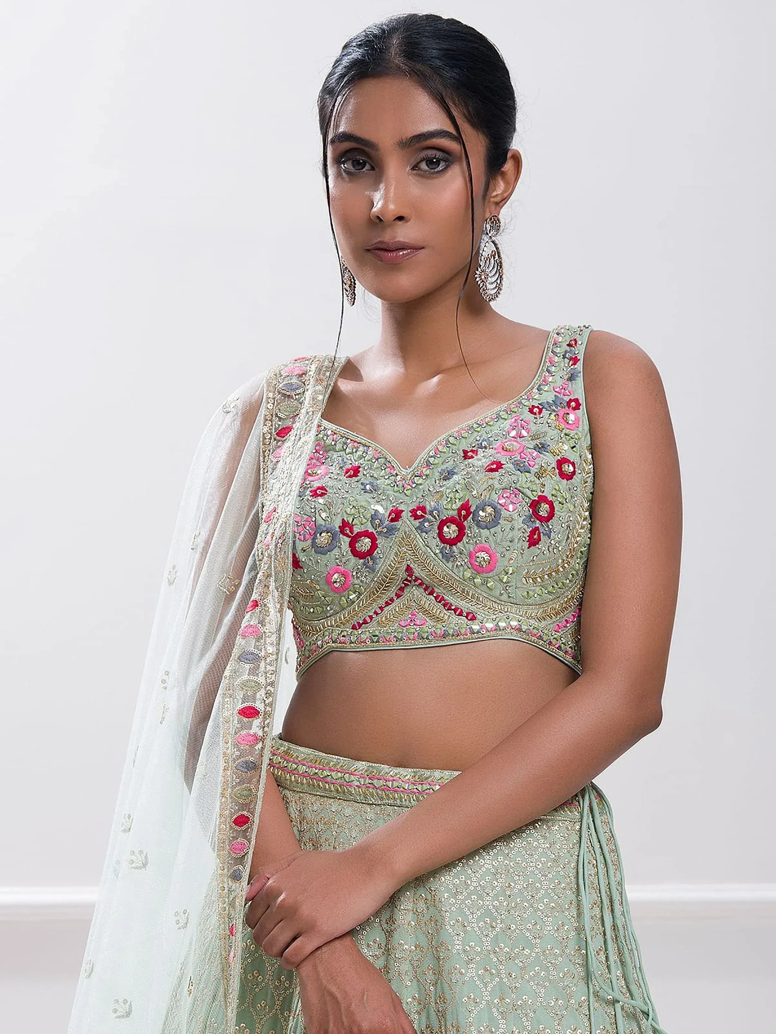 Mint green embroidered lehenga choli with floral motifs and sheer dupatta, perfect for Indian ethnic wear