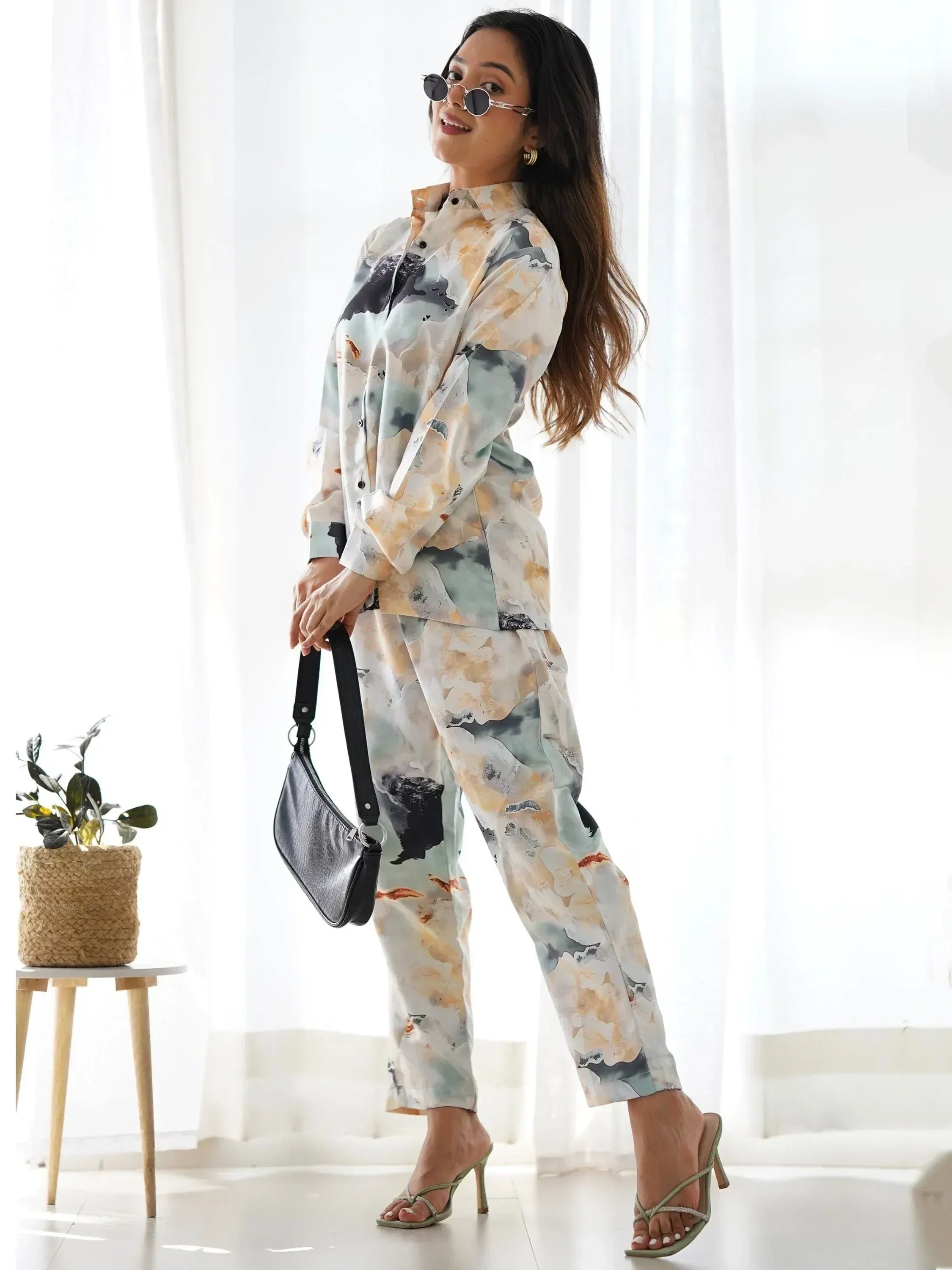 Woman in floral print ethnic co-ord set with sunglasses and heels, stylish Indian wear