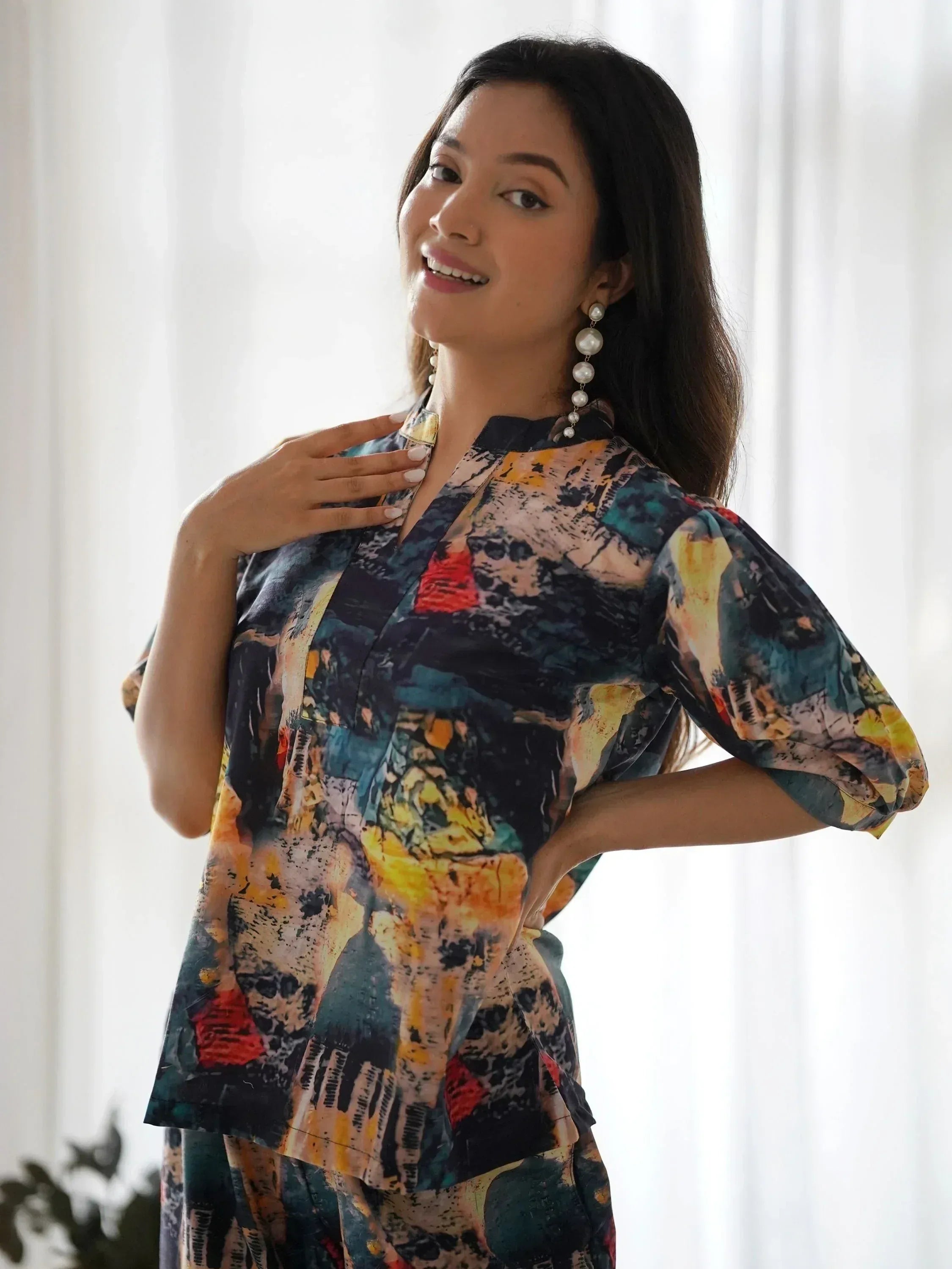Woman in colorful abstract print ethnic gown with puff sleeves, perfect for Indian occasions