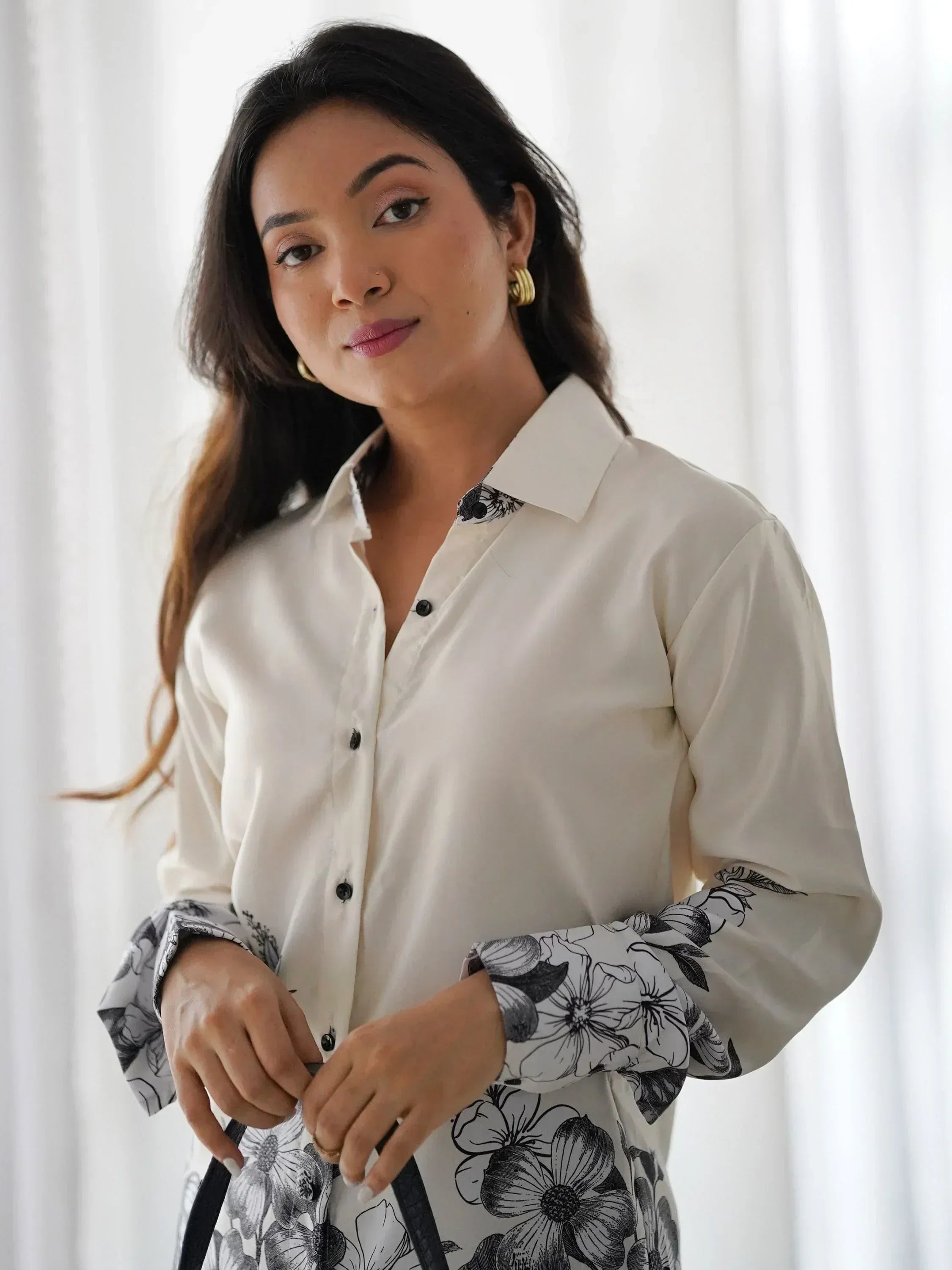 Elegant white floral print shirt with black buttons and stylish cuffs, perfect for ethnic wear.