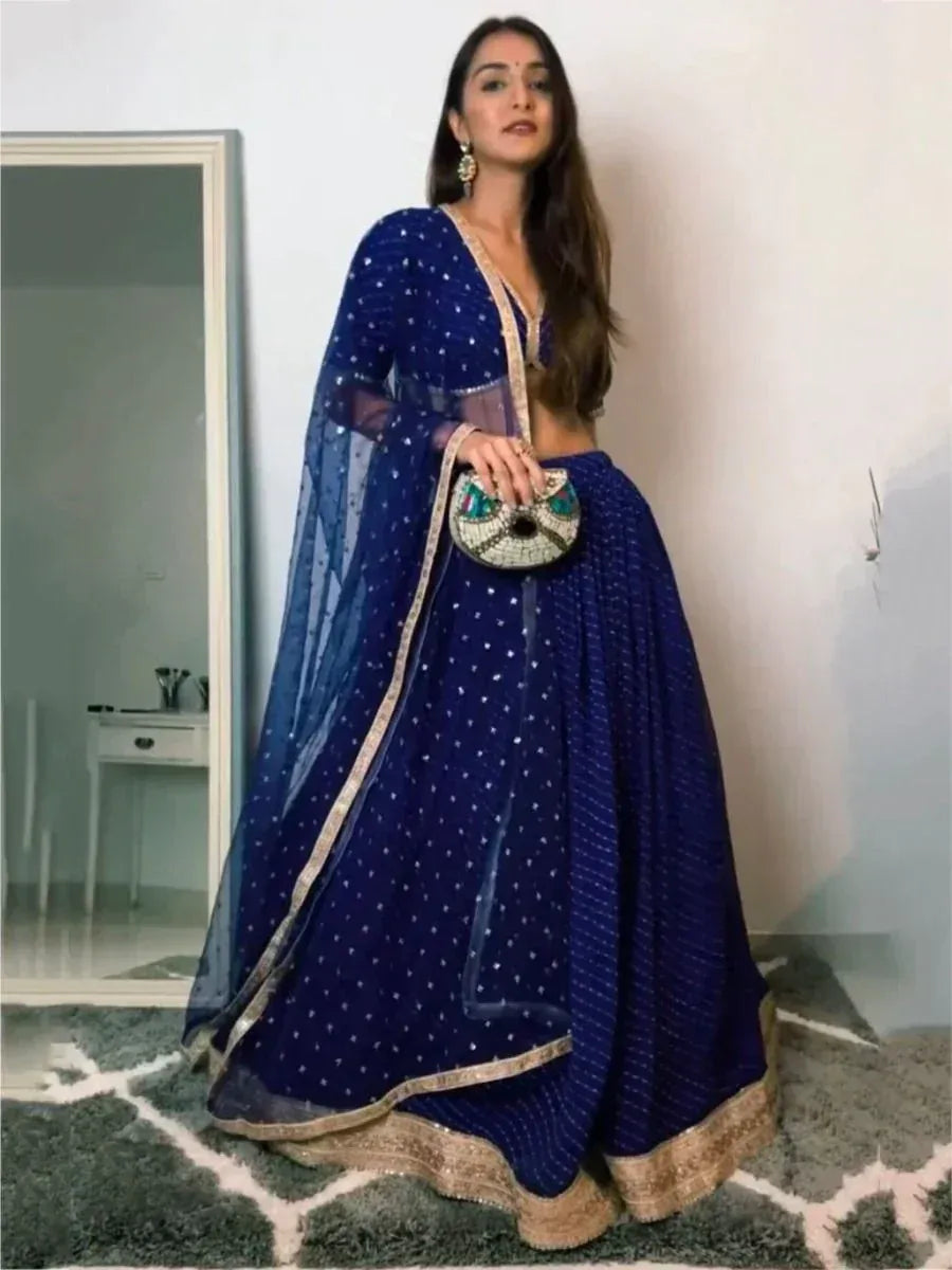 Royal blue designer lehenga choli with gold trim and sheer dupatta, perfect for Indian ethnic occasions