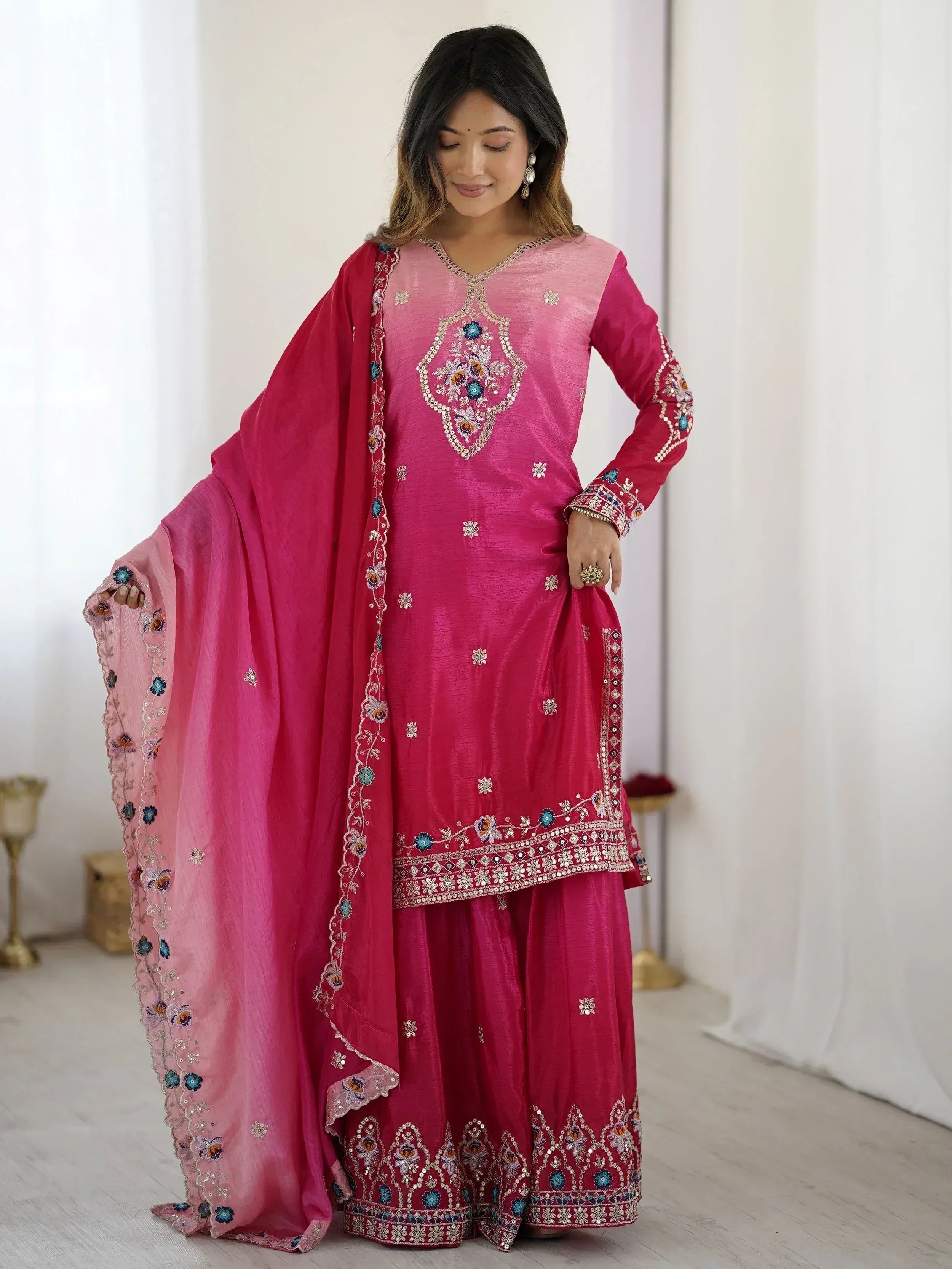 Pink embroidered salwar kameez with floral motifs and matching dupatta, ideal for ethnic occasions