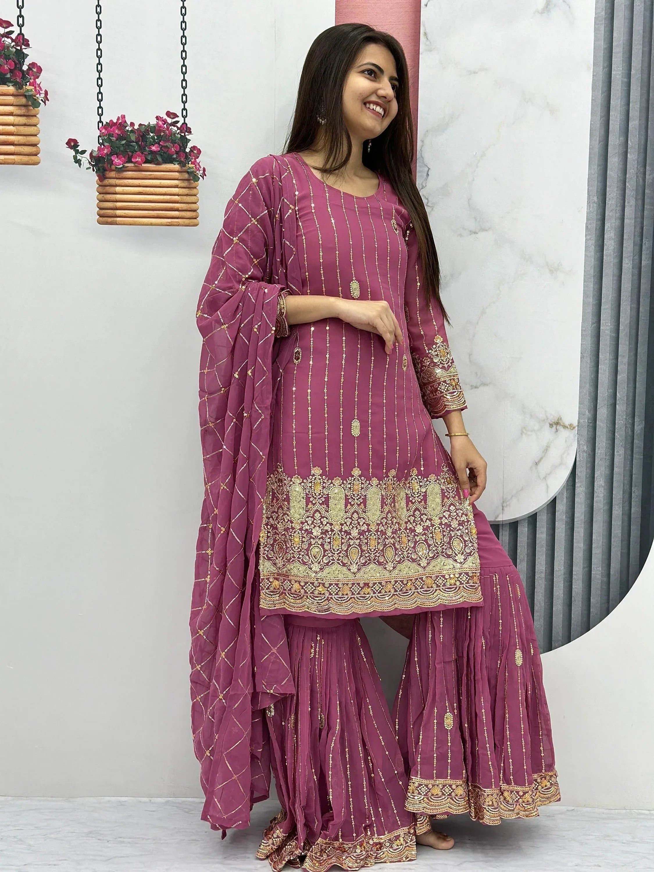 Woman in maroon ethnic salwar kameez with gold embroidery and dupatta, Indian designer wear