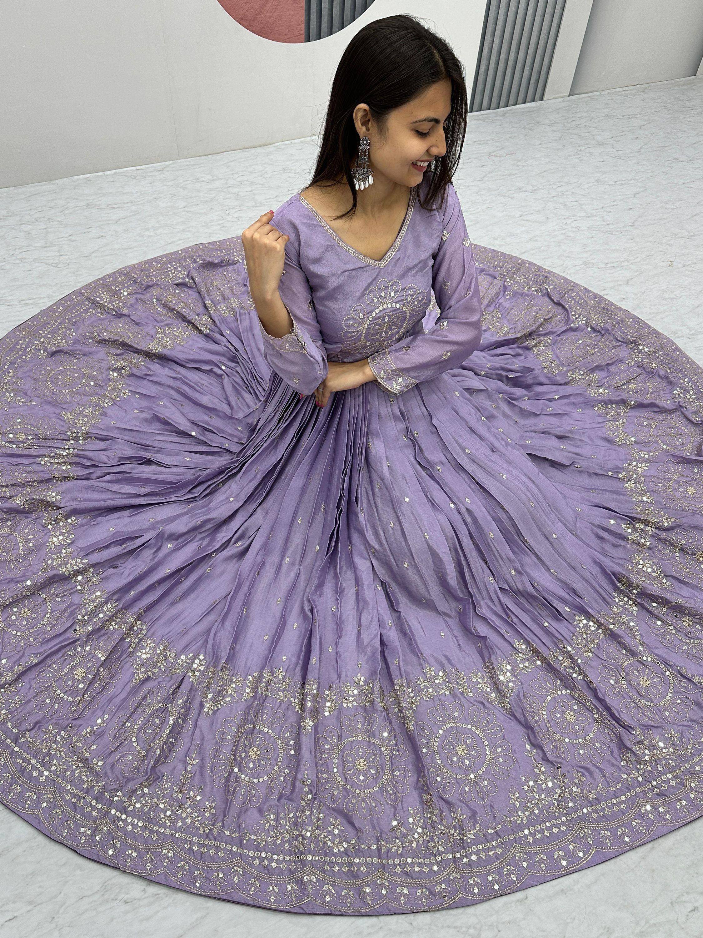 Lavender ethnic gown with gold embroidery, perfect for Indian weddings and festive occasions.