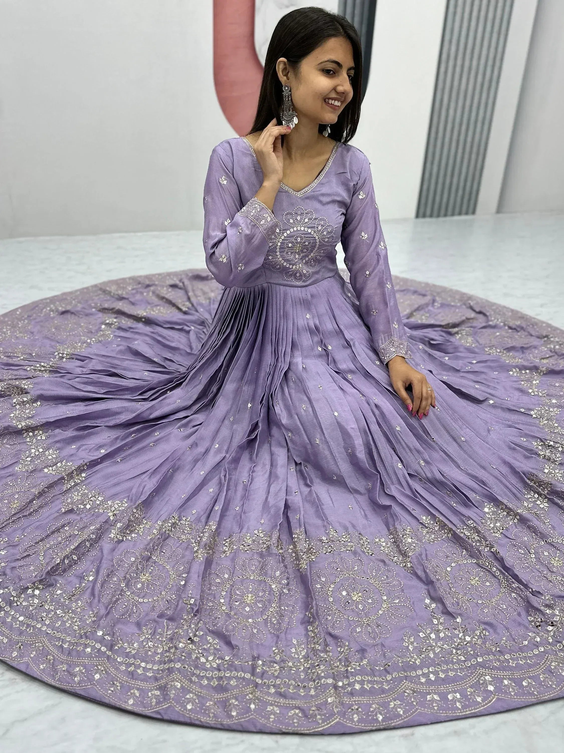 Lavender ethnic gown with intricate silver embroidery and pleated skirt, perfect for festive occasions.