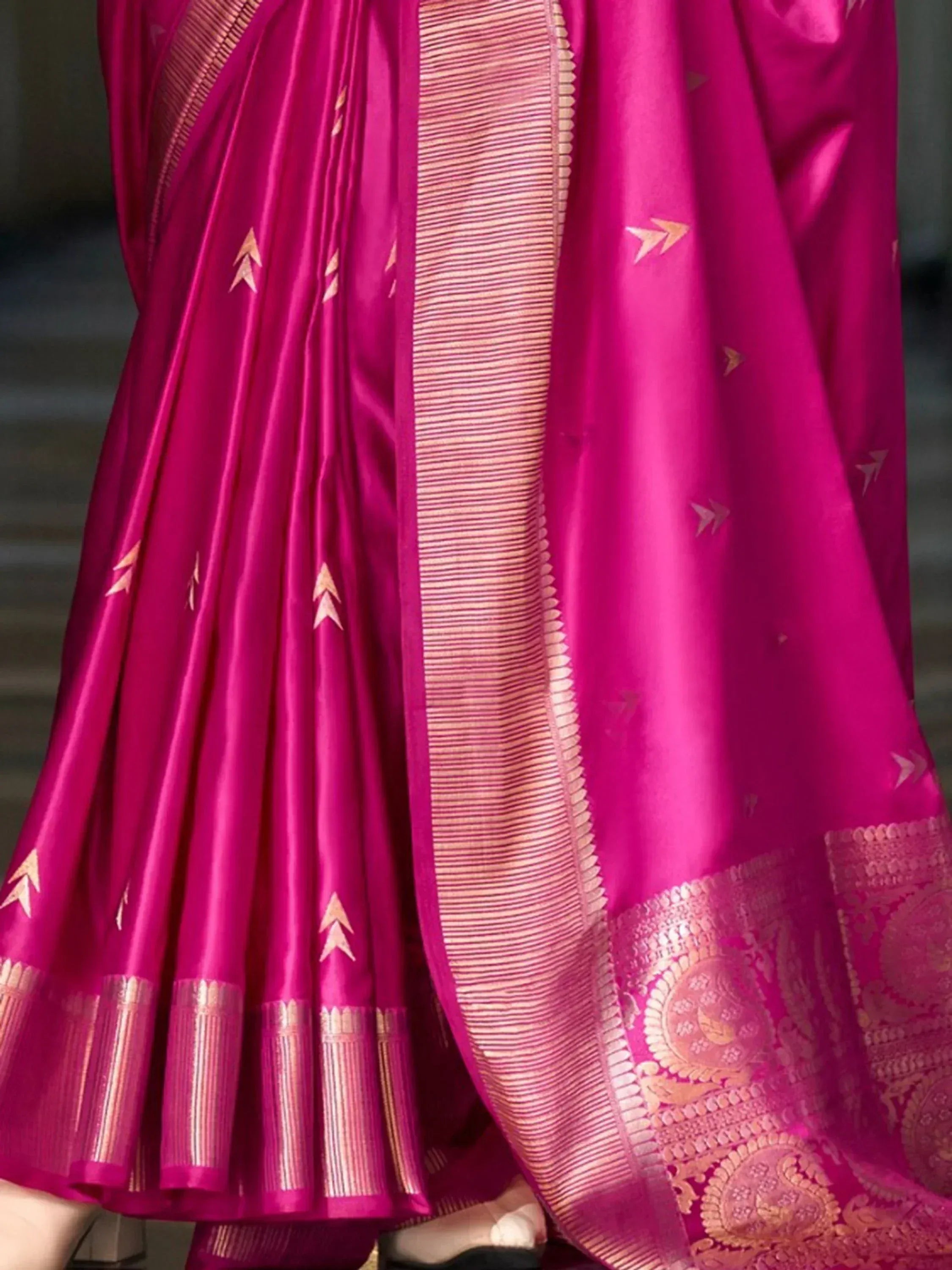 Vibrant pink silk saree with gold arrow motifs and intricate border, perfect for ethnic occasions
