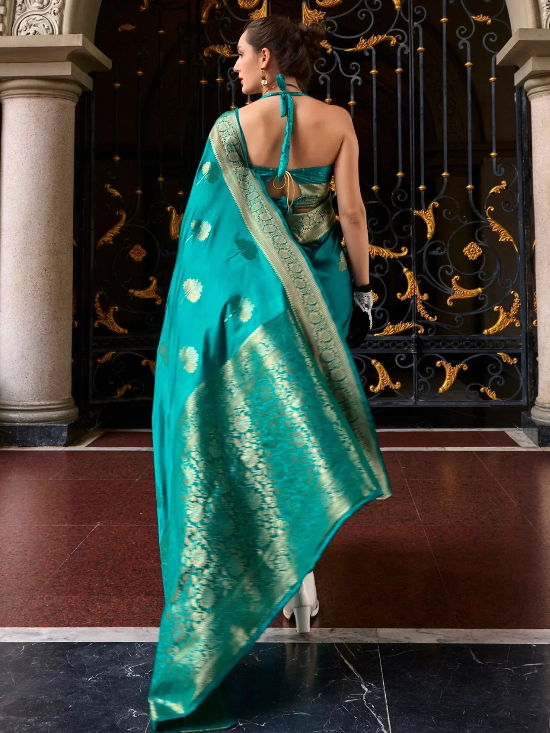 Teal designer saree with gold floral motifs and backless blouse, elegant ethnic wear for women