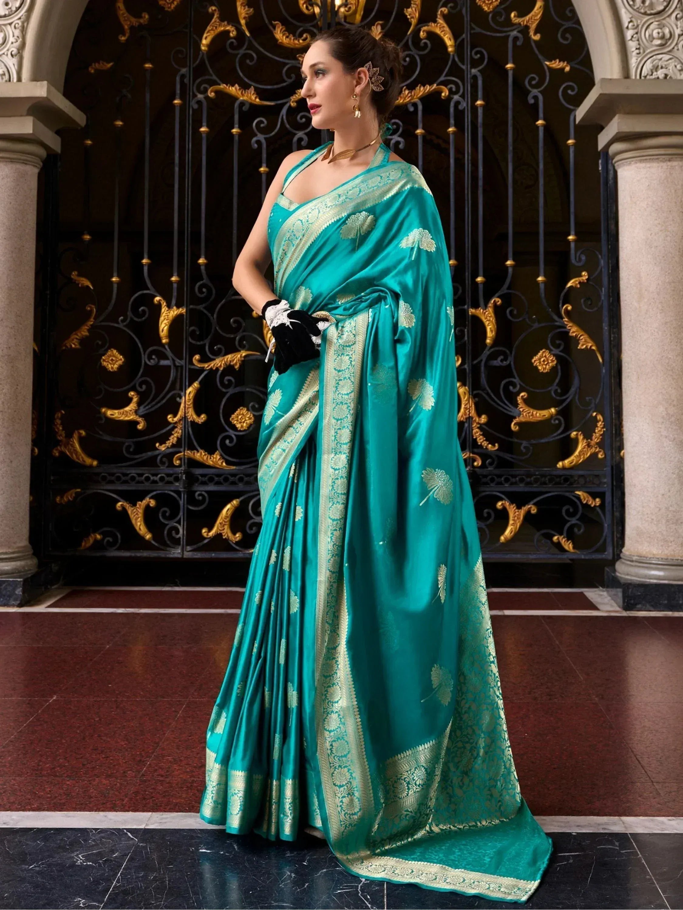 Teal silk saree with gold floral embroidery and border, styled for Indian ethnic wear occasions.