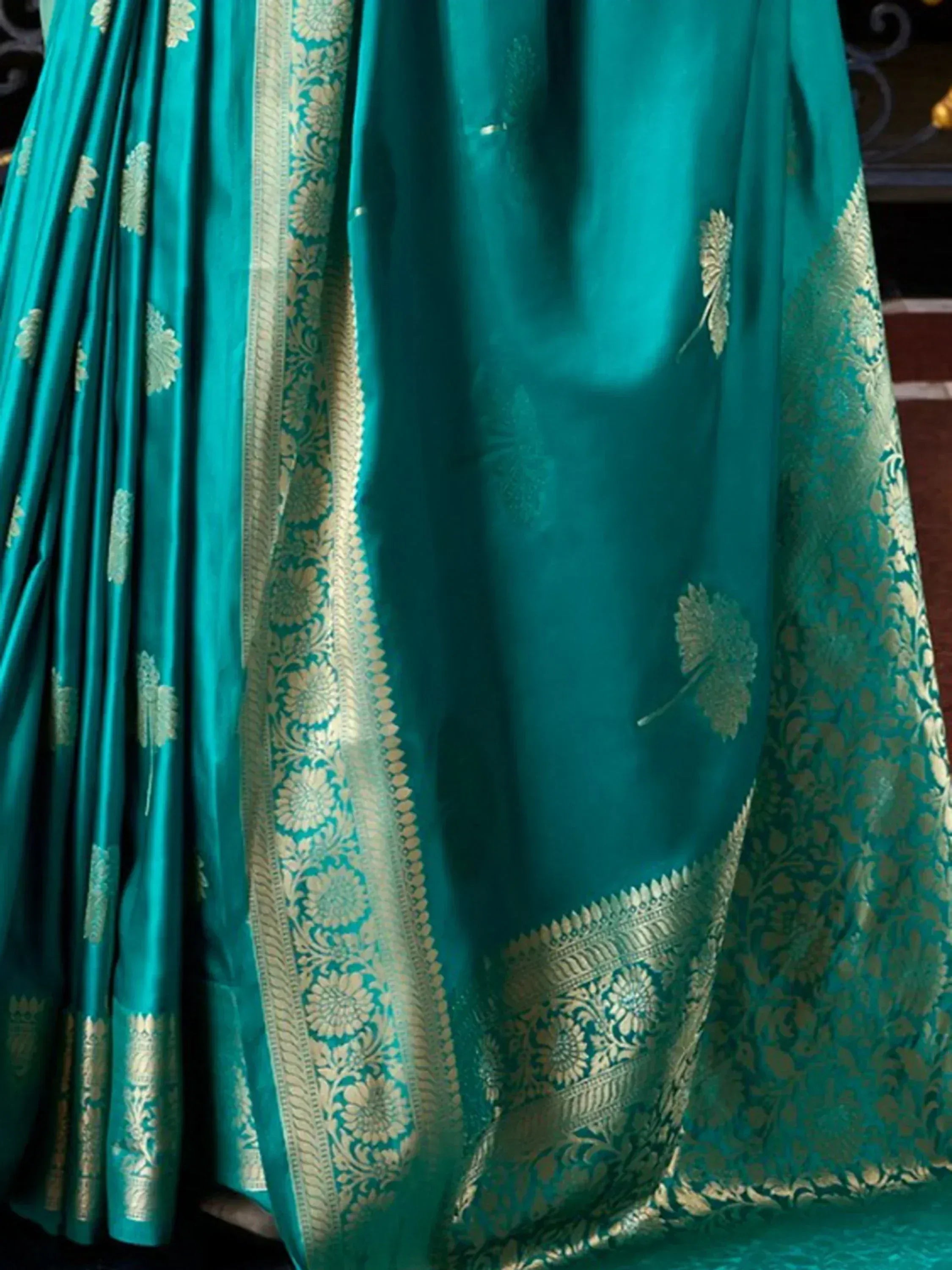 Teal designer lehenga choli with gold floral embroidery and rich brocade border, perfect for Indian ethnic wear.